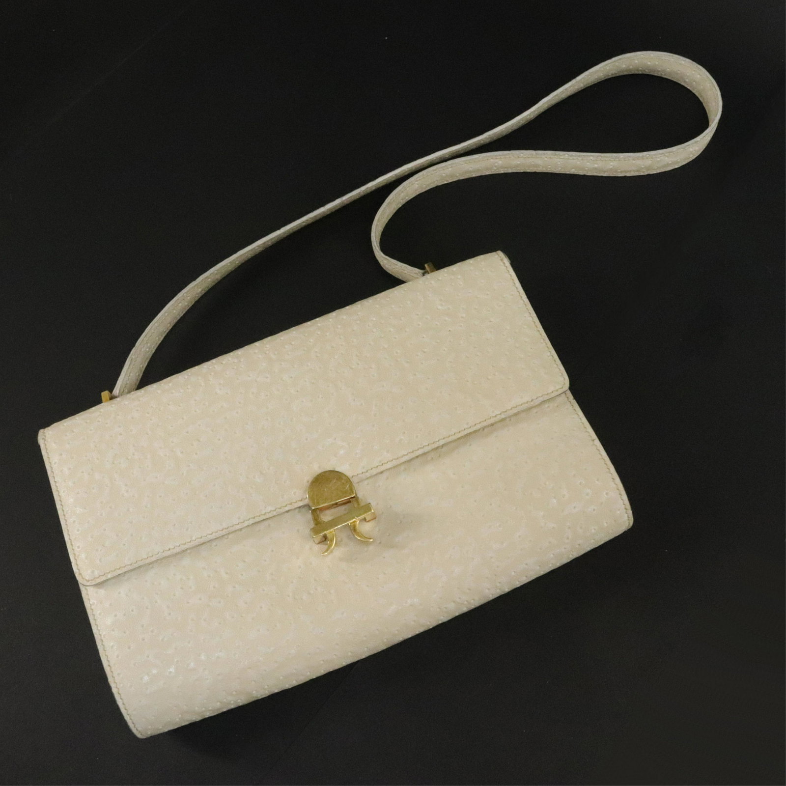 Vintage Hermes Whale Skin Handbag: A vintage Hermes Whale Skin handbag with off white calfskin leather interior; one slip and one zip pocket; brass hardware. Foil stamped Hermes Paris on front. Stamped Hermes on clasp. 7 x 9.75 x 2. 13