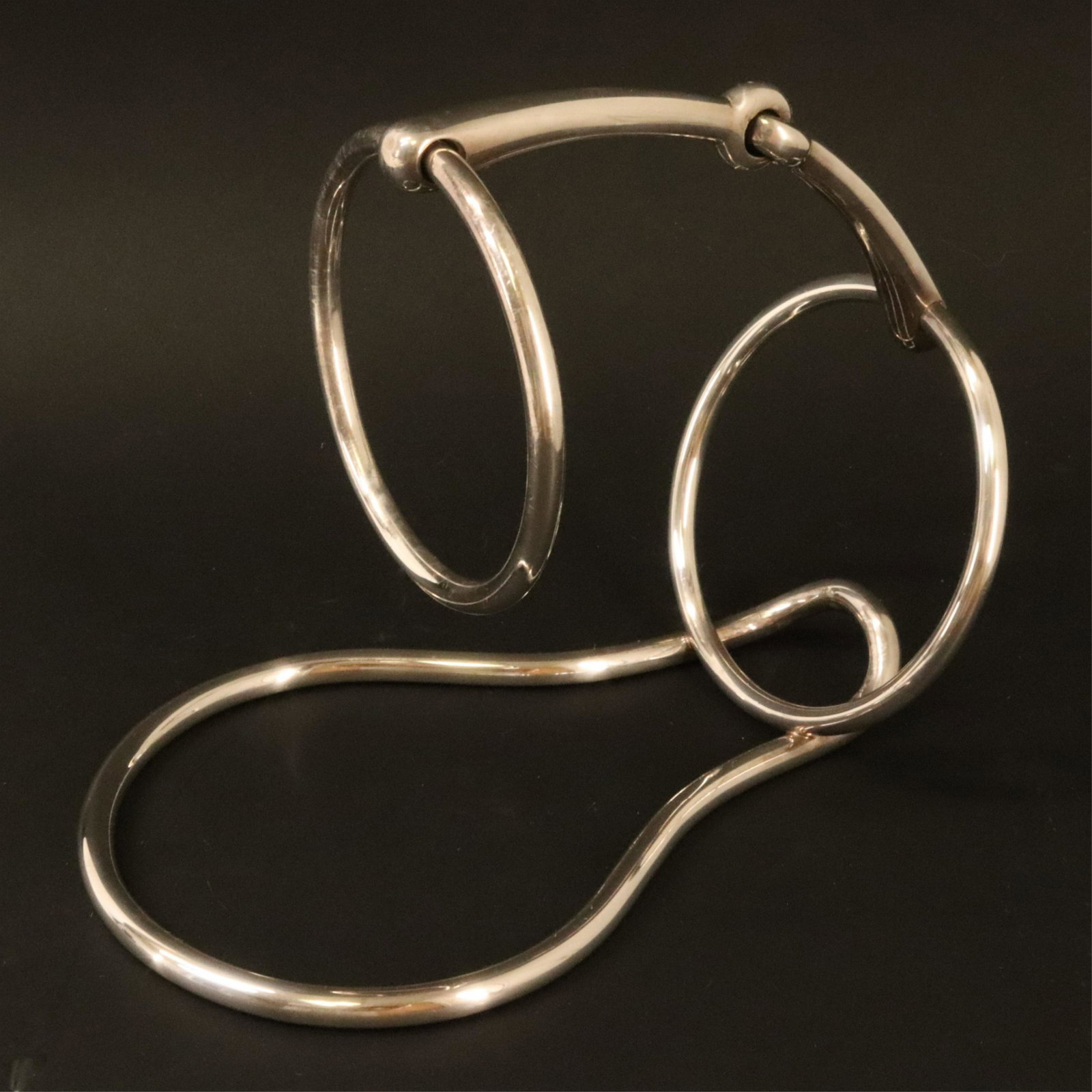 Hermes Silverplate Wine Bottle Holder: snaffle bit design c. 1950s, France, stamped "Hermes Paris" Dimensions: 7"H x 9"W From a Historic Falls Village Connecticut Home (SMOM233)(MM)