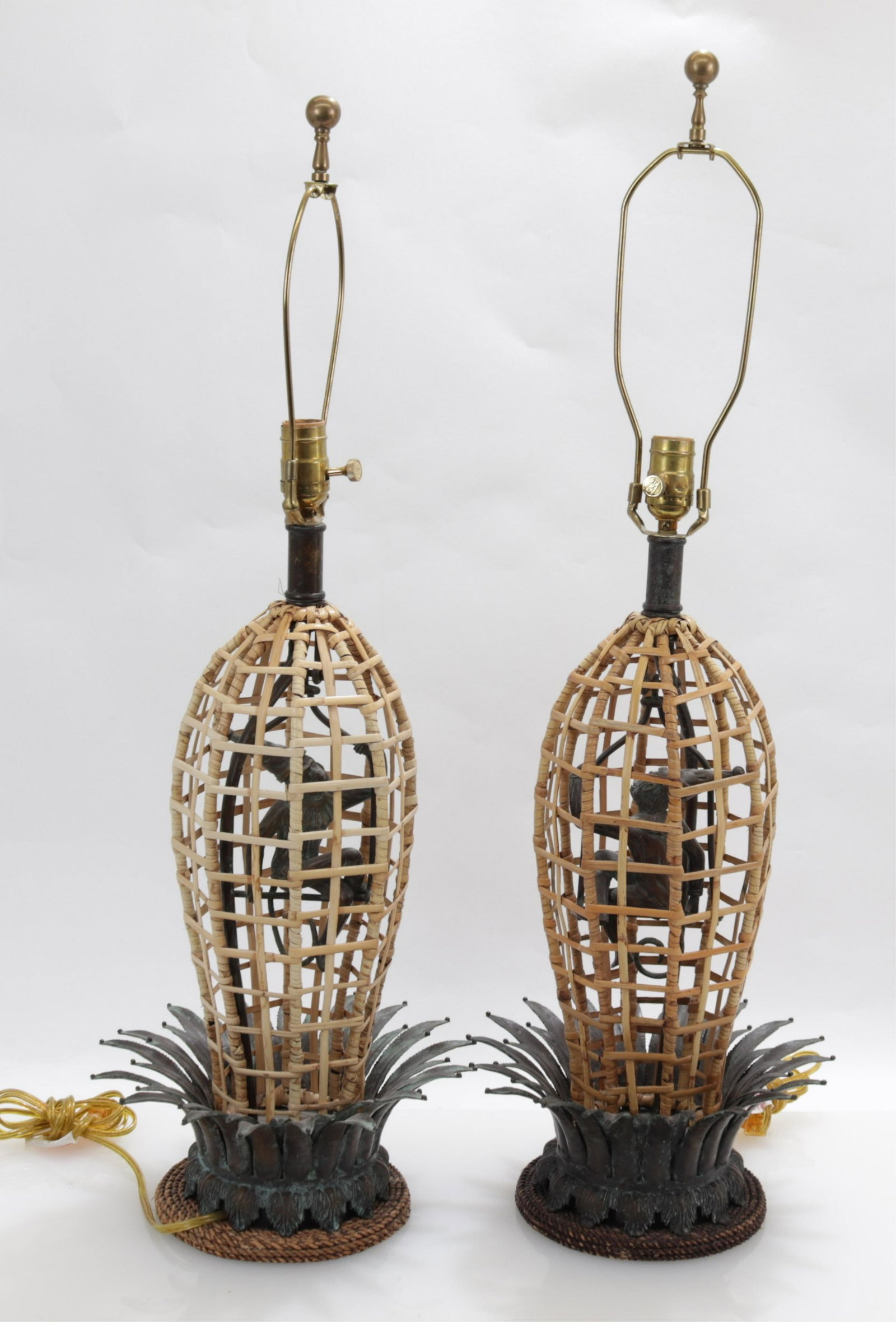 Pair of Rattan & Patinated Bronze Lamps: Pair Rattan & Patinated Bronze Lamps, with bronze monkey on a swing Dimensions: 19" H x 11" W, overall 34" H Property from the Private Collection of Steven Stark (ALPI142)(WT)