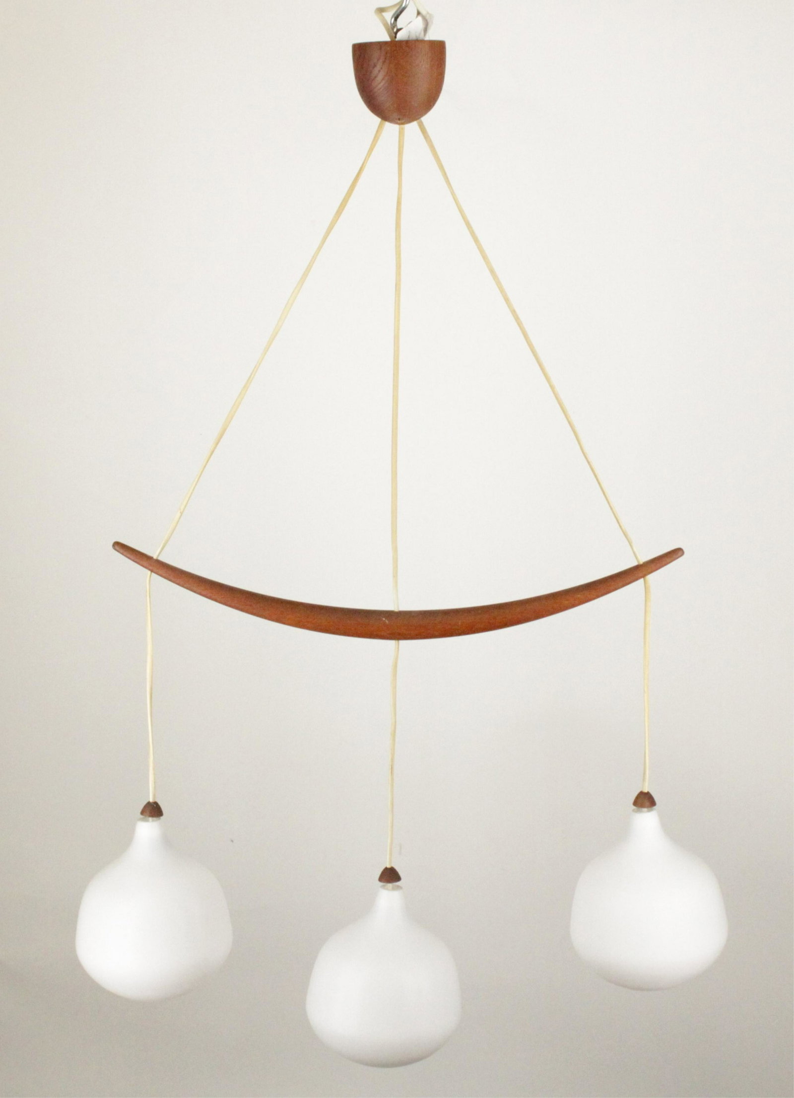 Uno & Osten Kristiansson for Luxus Chandelier: Swedish MCM Pendant Chandelier designed by Uno & Osten Kristiansson for Luxus c.1960, model 512 wood with opalescent glass Dimensions: 40"H x 25"W (GOLD559)(MM)