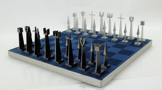 Austin E Cox, Modernist Chess Set, 1962: Aluminum Pieces In wooden case with Blue Plexi glass Cover, Display Case can be Wall Mounted, Pieces are Dated, Black and Blue Felt Chess Board Dimensions: Pieces appr. 3.75 - 4.5" Tall Box: 30.5" lon