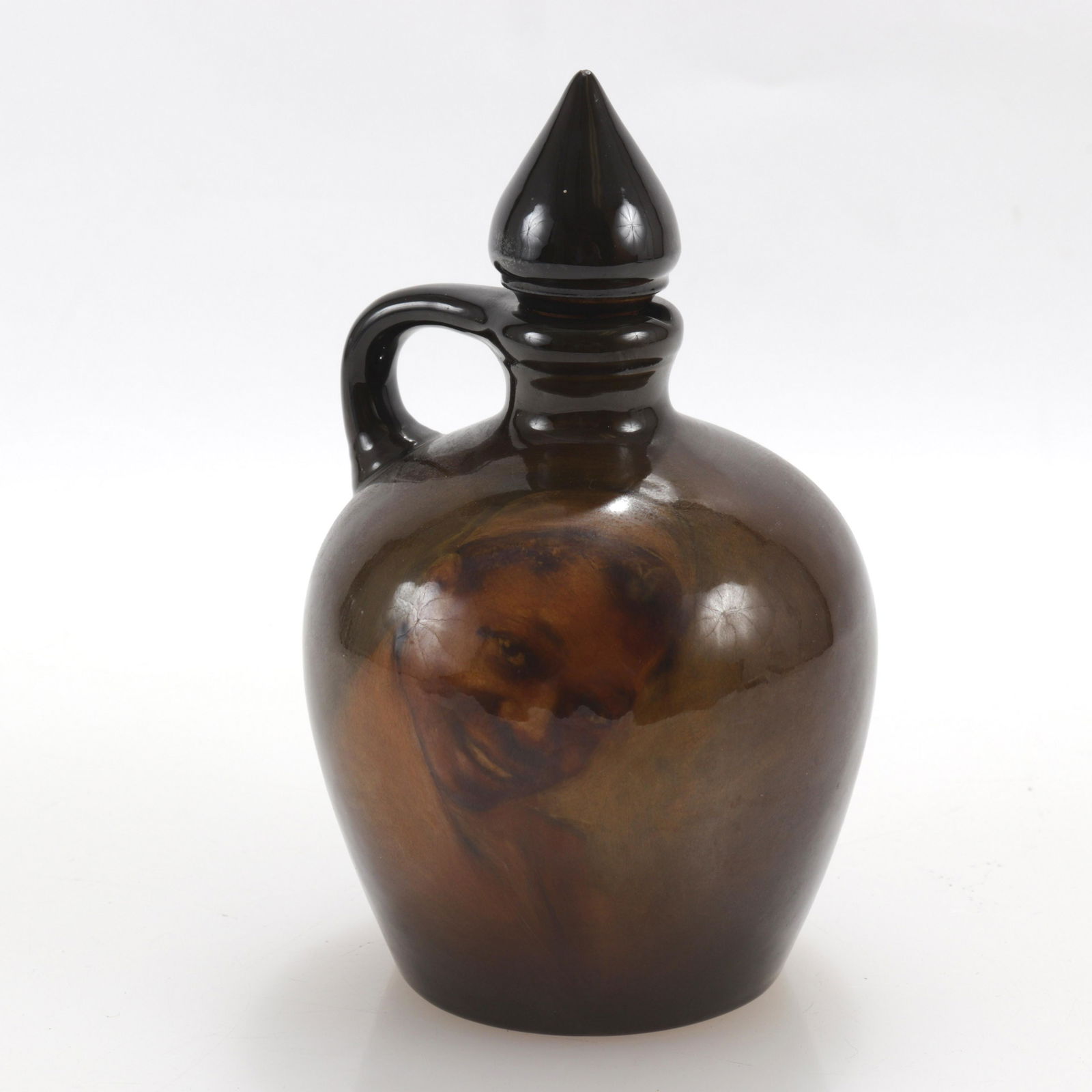 Olga Geneva Reed for Rockwood, Decanter: Olga Geneva Reed for Rockwood, glazed pottery decanter with painting of boy, 1899. Initialed and stamped on bottom. Dimensions: Property from a Chestnut Hill, MA Estate (FANN291)(EL)