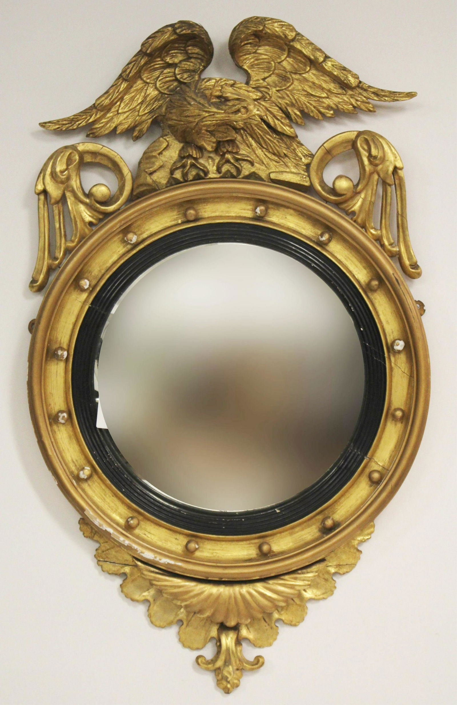 Federal Giltwood and Carved Convex Mirror, 19th C.: Federal Giltwood and Carved Convex Mirror, 19th C. surmounted by later eagle and floral scrollwork Dimensions: 43"H x 26"W x 6 1/2"D (LCA842)(MM)