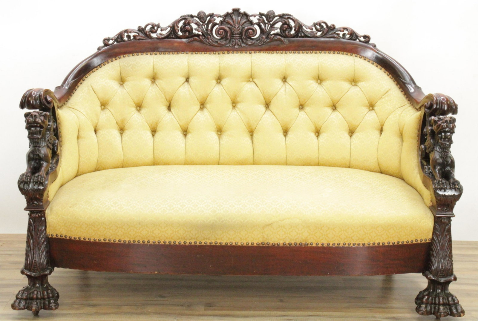 Manner of Horner Renaissance Revival Sofa: Manner of R.J. Horner Renaissance Revival Sofa with tuft upholstered with carved lions head armrests and hairy paw feet Dimensions: 43"H x 65"W x 35"D (JVAN138)(MM)