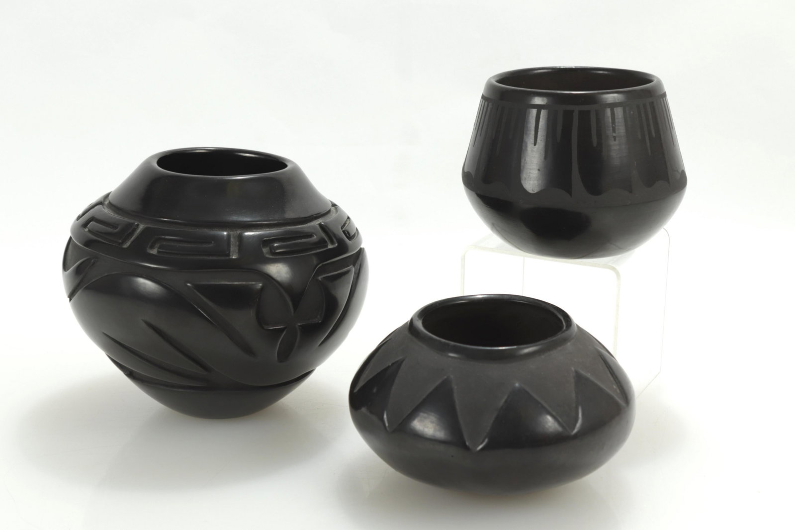 Group of Santa Clara Blackware Pottery: - Santa Clara carved blackware jar, Pat A. Martinez, 6" diam- Santa Clara carved blackware jar, Petra Gutierrez, 5.25" diam- Santa Clara carved blackware jar, Jennifer J. Naranjo, 7" diam Dimensions: 
