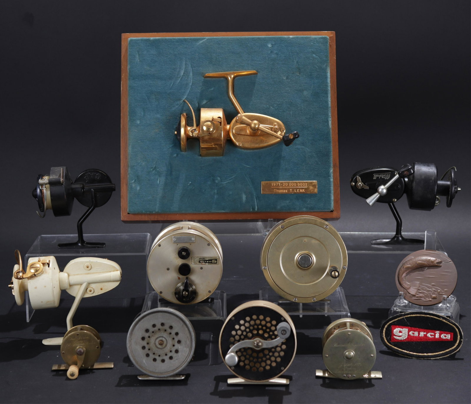 Collection Fishing Reels, Mitchell Garcia & more: From the personal collection of Thomas Lenk. Many engraved. Includes: Fin Nor No.3 Designed by Gar Wood Jr. 3-452 (Tom Lenk metal plate badge) (fly). S.E.Bogdan Nashua N.H. Garcia WF-8-F (larger fly o