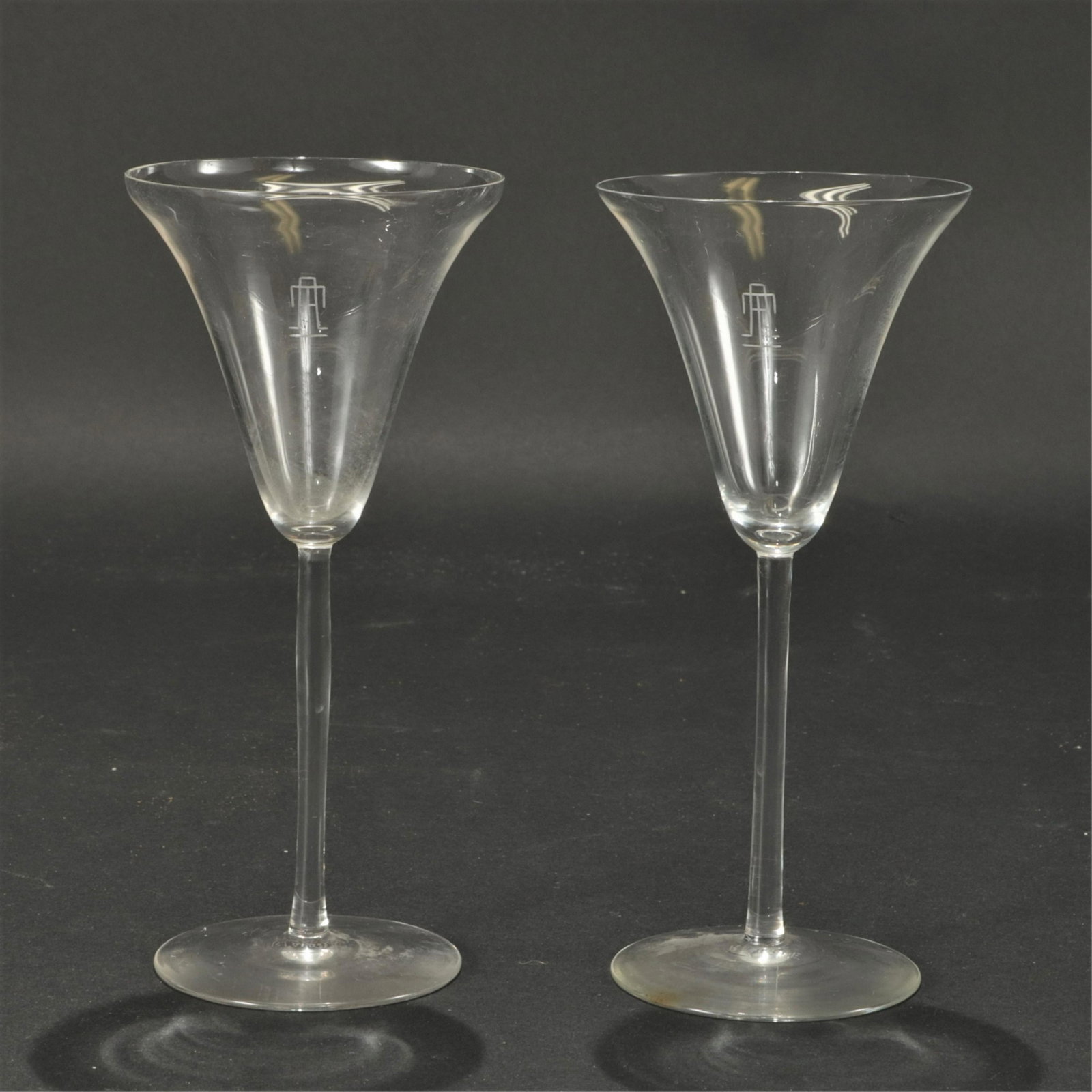 Set of 26 R. Lalique Sevres Red Wine Glasses: A set of 26 Sevres pattern red wine glasses by R. Lalique. Each acid etched "R. LALIQUE / France" on bottom. Monogrammed TA. Dimensions: 7 7/8" H x 3 5/8" diam Property from a successful Sotheby's rea