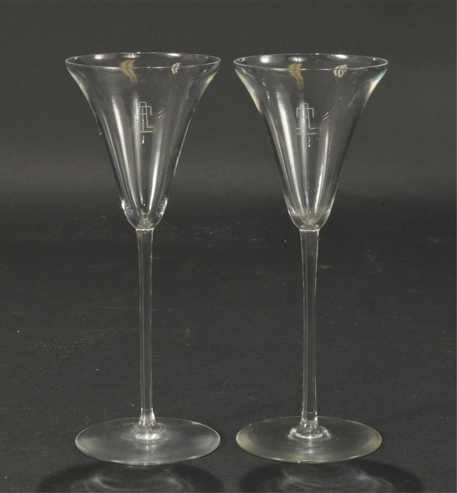 Set of 24 R. Lalique Sevres White Wine Glasses: A set of 24 Sevres pattern white wine glasses by R. Lalique. Each acid etched "R. LALIQUE / France" on bottom. Monogrammed TA. Dimensions: 7 13/16" H x 3" diam Property from a successful Sotheby's rea