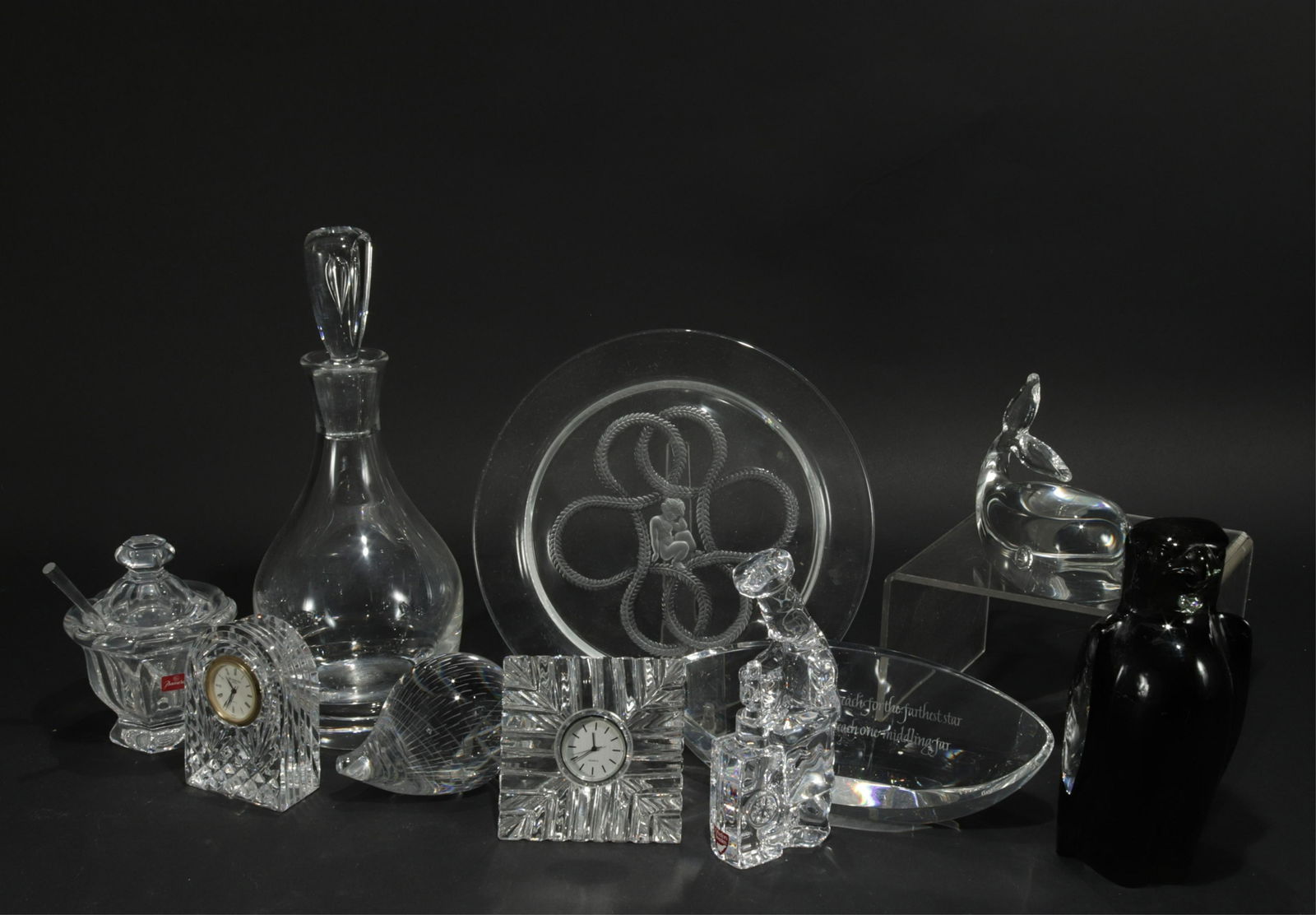Collection of Crystal Objects: Including Steuben motivational paper weight, whale, and decanter. Waterford clock. Baccarat mustard. Kosta hedgehog. Orrefors chef. Lalique plate with cherub. Svenskt eagle. (MLEN149/10)(EL) Property