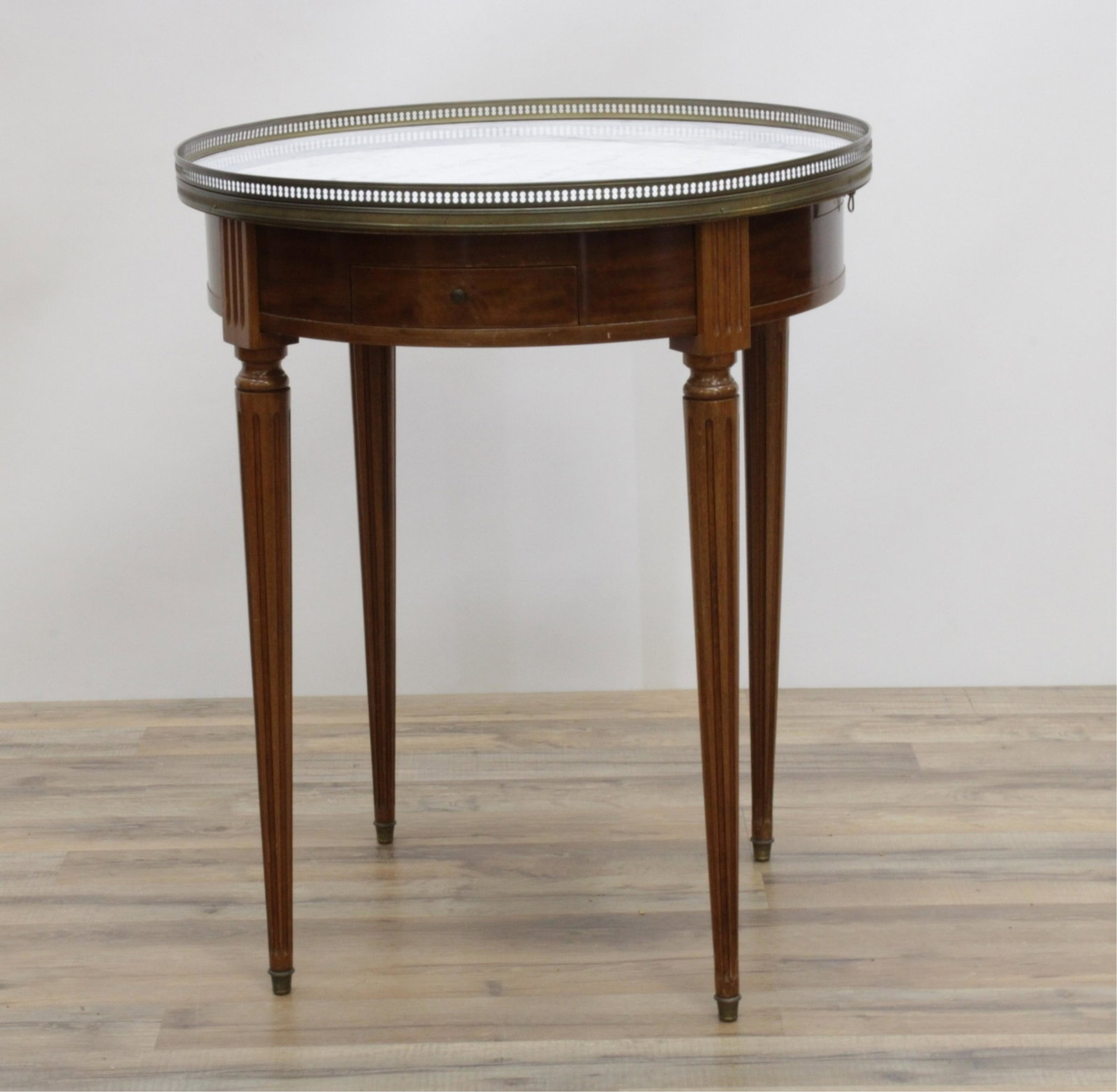 Marble Top Louis XVI Style Gueridon Table: 24.375 dia by 29.5 h to top of pierce gallery rail Property from a Dobbs Ferry home