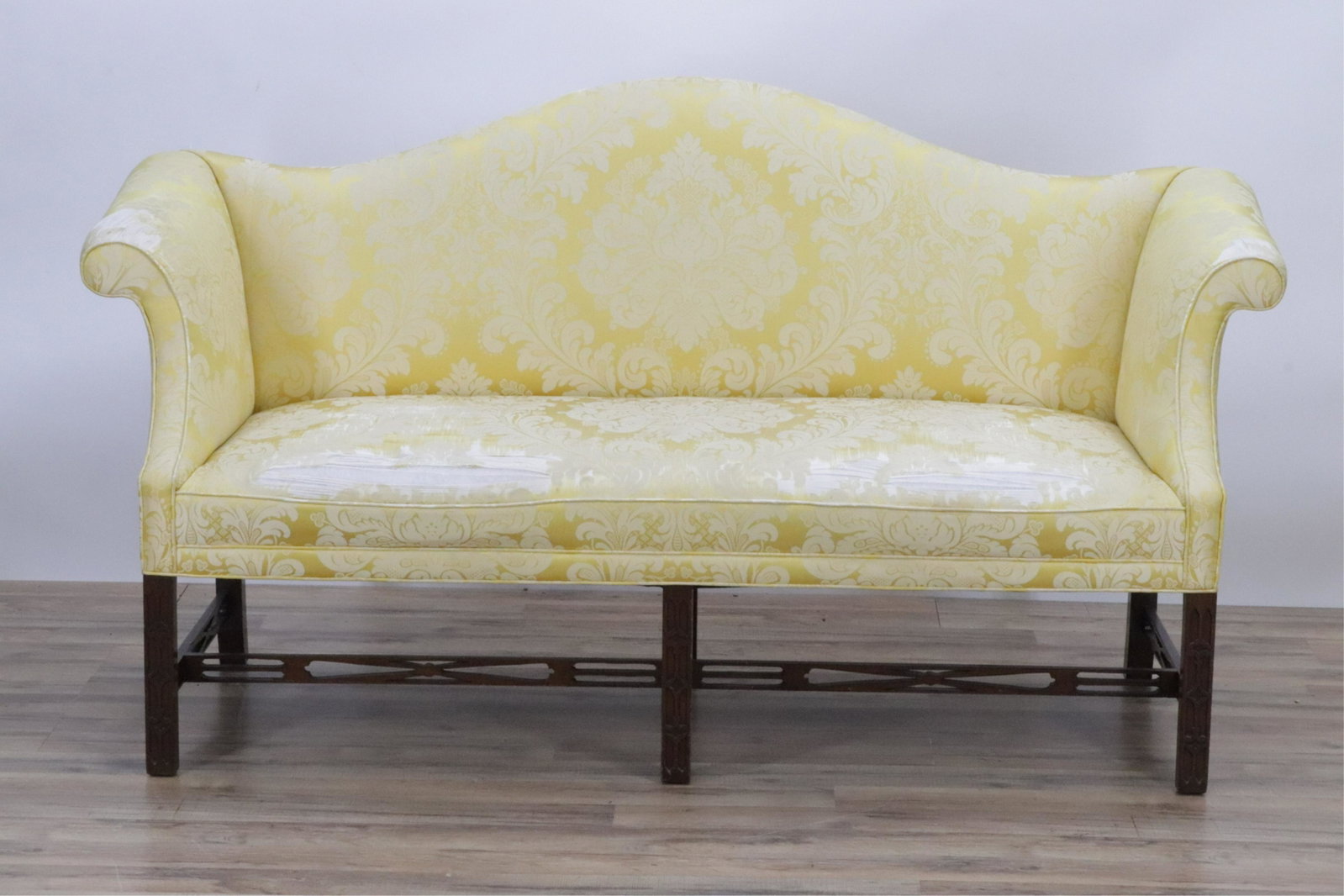 George III Style Mahogany Loveseat: George III Style Mahogany Loveseat, blind-fret carved, upholstered in gold silk damask 37" H x 67" W x 25" D Property from the Estate of Mariam S. Poser