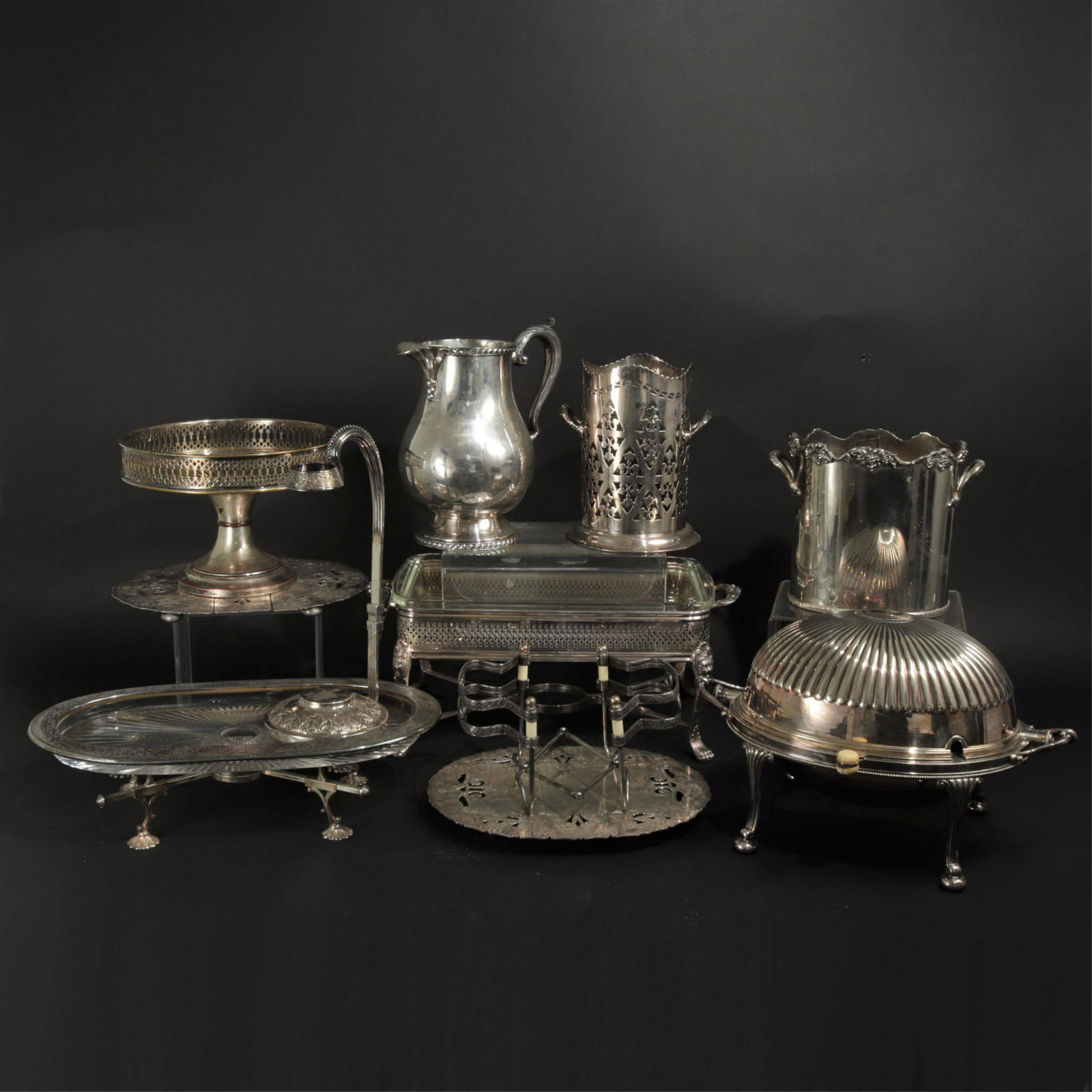 Group of Silver Plate Items: Including pitcher, wine chiller, wine bucket, and four dish trivets.Dimensions: Various Shipping is the buyer's responsibility! We recommend obtaining a quote from a third party shipper prior to biddi