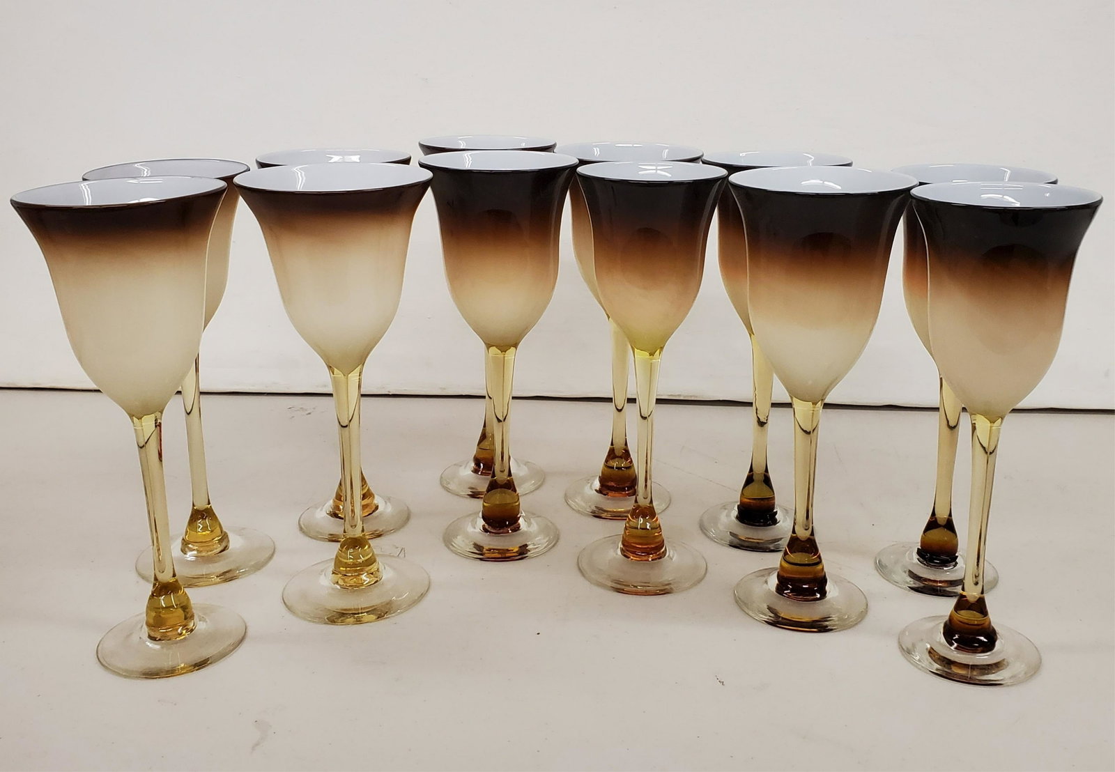 Set of 12 Colored Wine Glasses: Signed Cornell, hand blown, sizes varyDimensions: Various sizes, approx. 9.5" high x 3.25 - 4" Diameter Shipping is the buyer's responsibility! We recommend obtaining a quote from a third party shippe