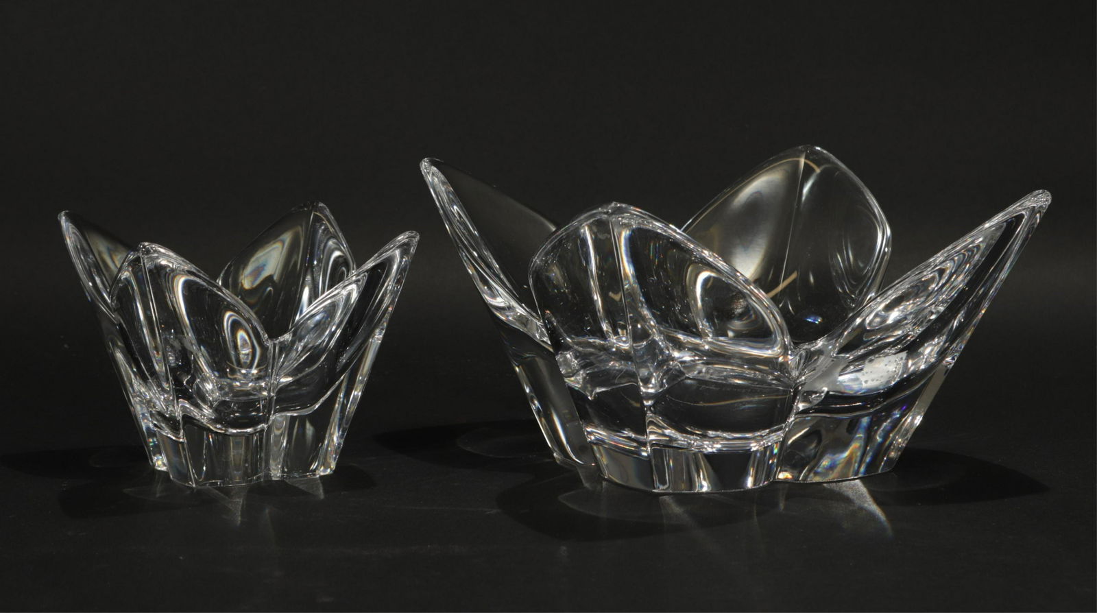 Set of Orrefors Lotus Bowls: Set of two Orrefors lotus form bowls, designed by Lars Hellsten. Each signed on bottom.Dimensions: 4.75 H x 7" sq and 4" H x 4.25" sq Shipping is the buyer's responsibility! We recommend obtaining a q