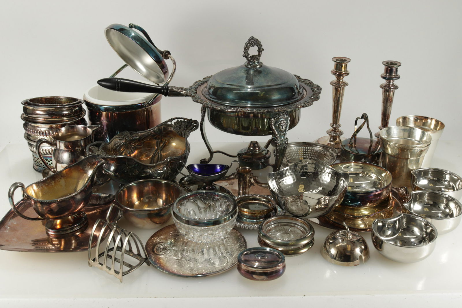 Group Silverplate & Metal Tableware: Chaffing dish, ice bucket, 5-wine coasters, 9-small trays, trivet, 7-bowls, 3-buckets, small pairpoint tureen, measure, box, cover, strainer, pr. candlesticks, small candlestick, pitcher, toast rack,