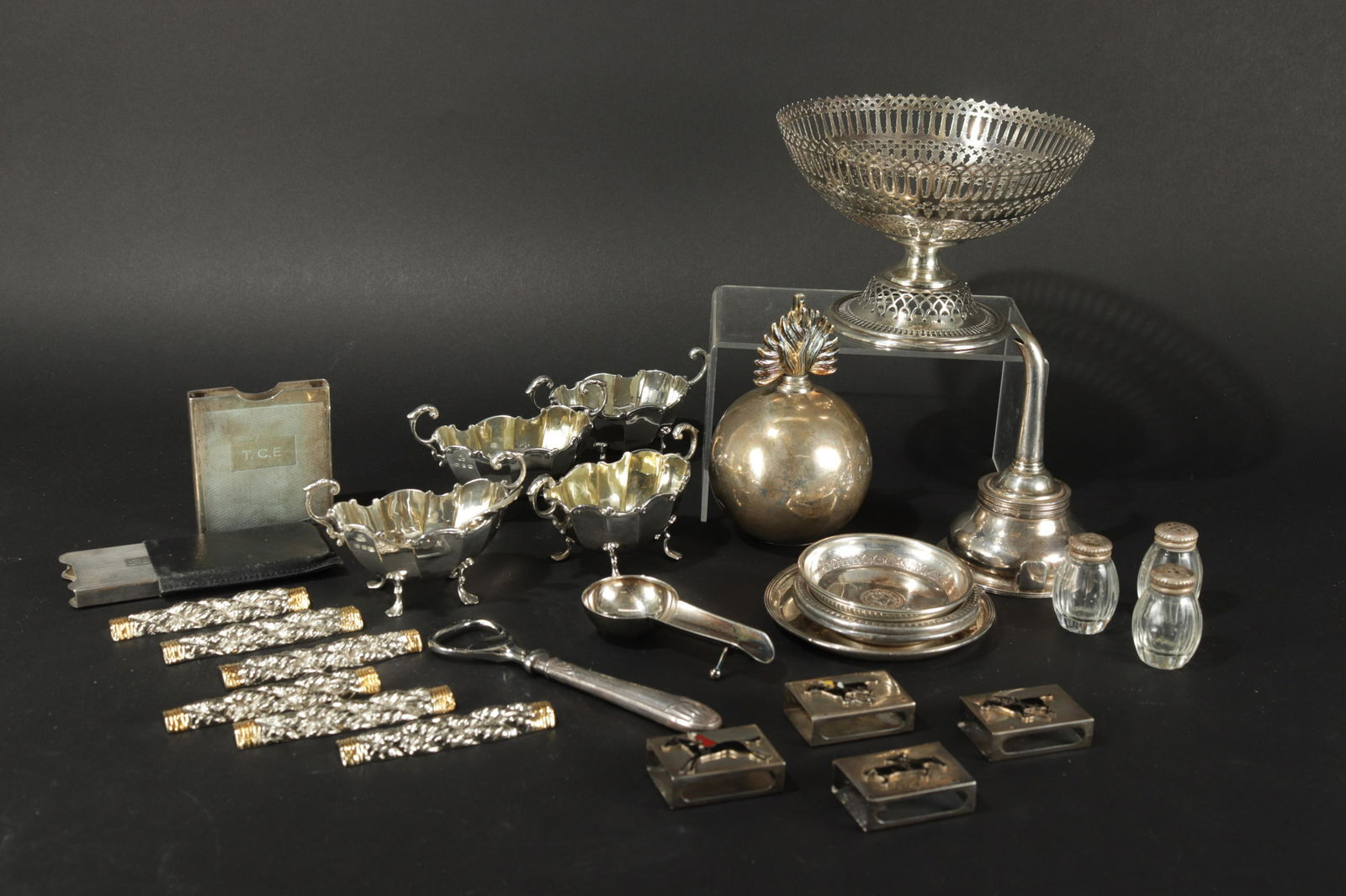 Group of Sterling Table and Desktop Objects: Group of Sterling Silver Tabletop and Desktop items, includes a wine funnel, (marks rubbed), Deakin & Francis cigar ashtray, 4 salt cellar spoons, 3 pats, 4 Henry Matthews condiment bowls, 2 monogramm
