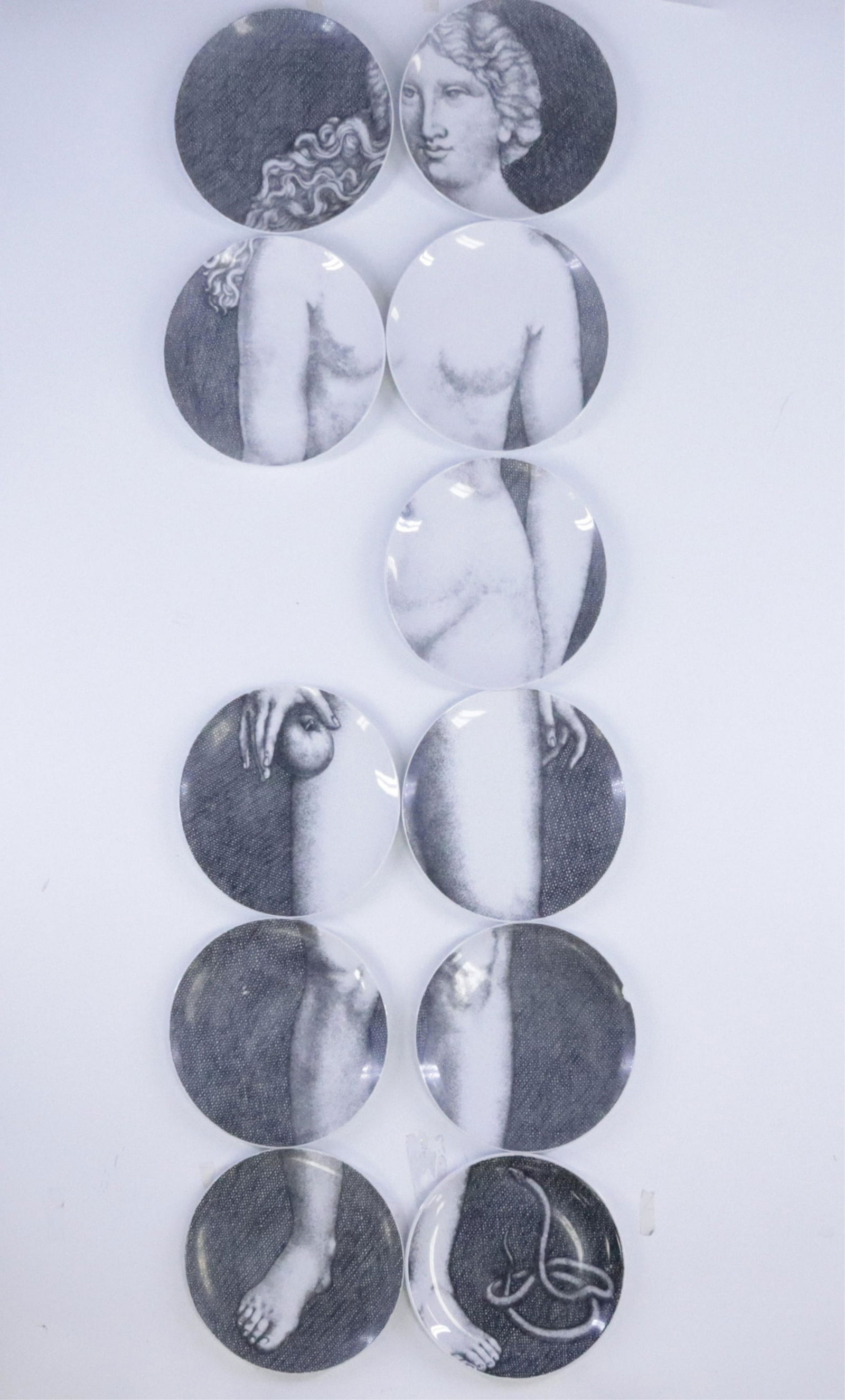 11 Piero Fornasetti Eve Plates: 11 of 12 Piero Fornasetti Eve Plates, Italy, transfer decorated porcelain, lacking no.7, all marked (JOHN118/11)(MM) Dimensions: 10 1/4" diameter