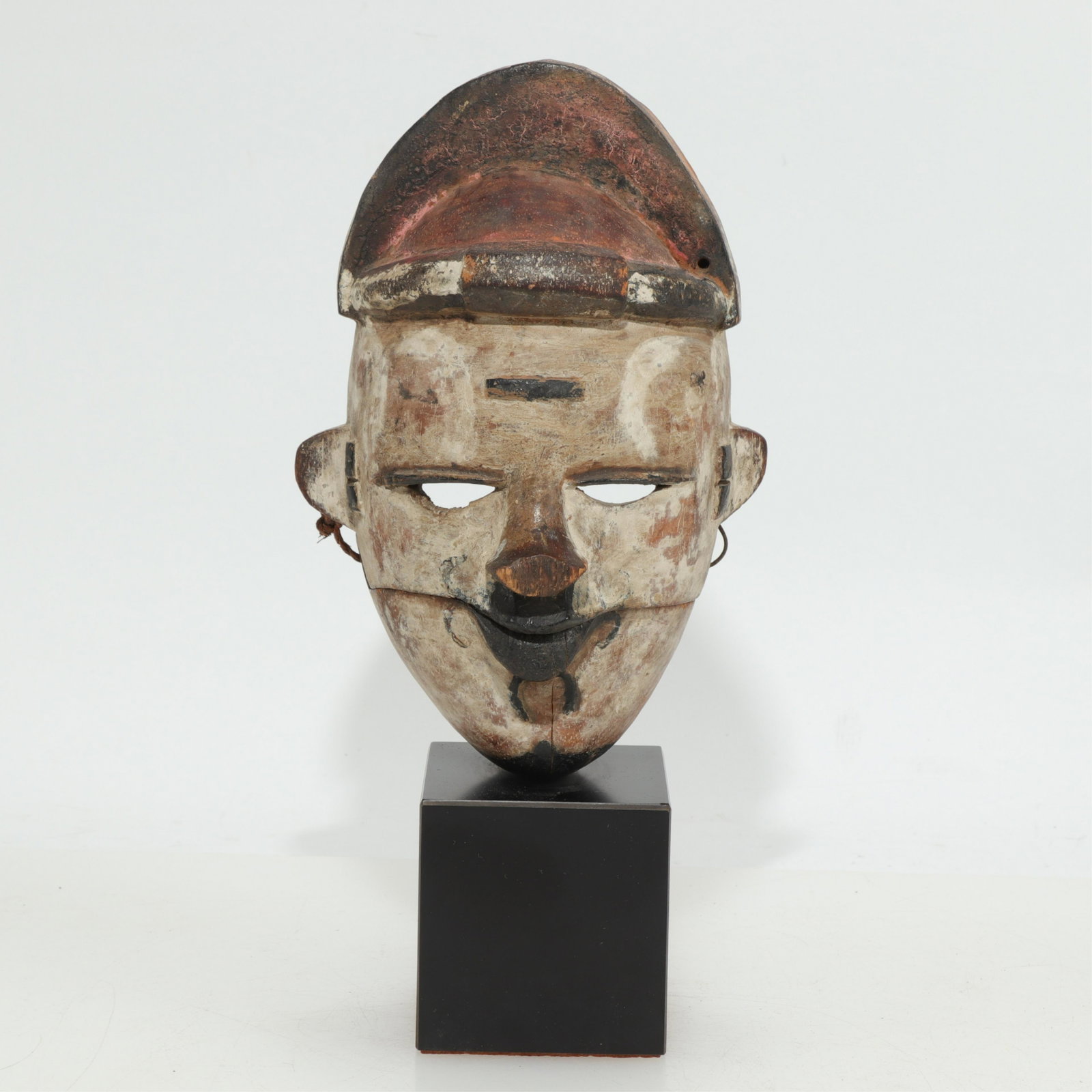 Ogoni Painted Wood Articulated Mask, Nigeria: Ogoni Painted Wood Articulated Mask, Nigeria, early 20th century mask professionally mounted (MST284)(MS) Dimensions: 8.75" H, overall 12" H Property from a private collection, Scarsdale, NY.