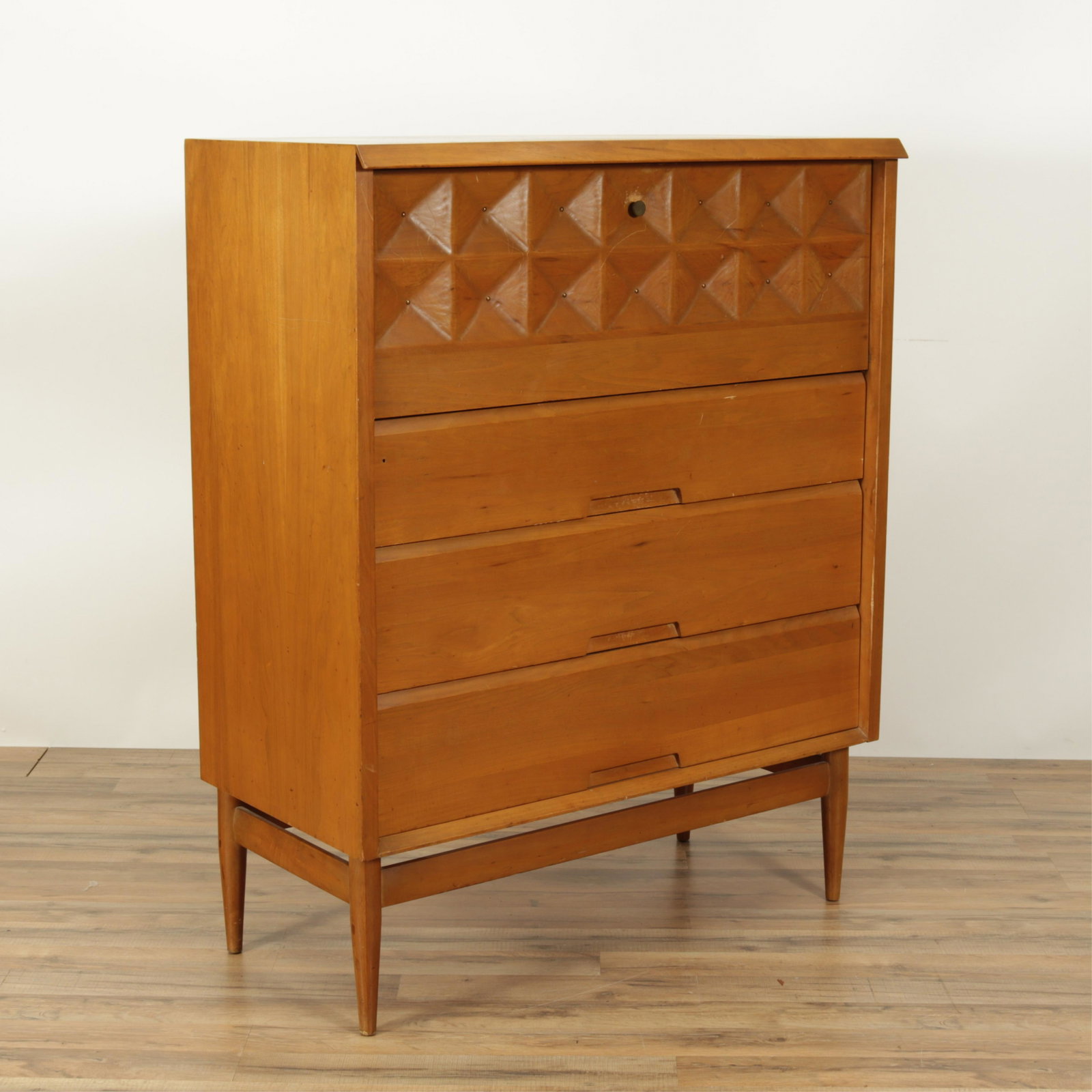 Salvatore Bevelacqua Birchwood Cabinet: Vertical cabinet with drop-down front over three drawers. Interior fitted with two slide out trays. Drop down door with hand chiseled/decorative tool marks inverted "pillow" squares each with center b