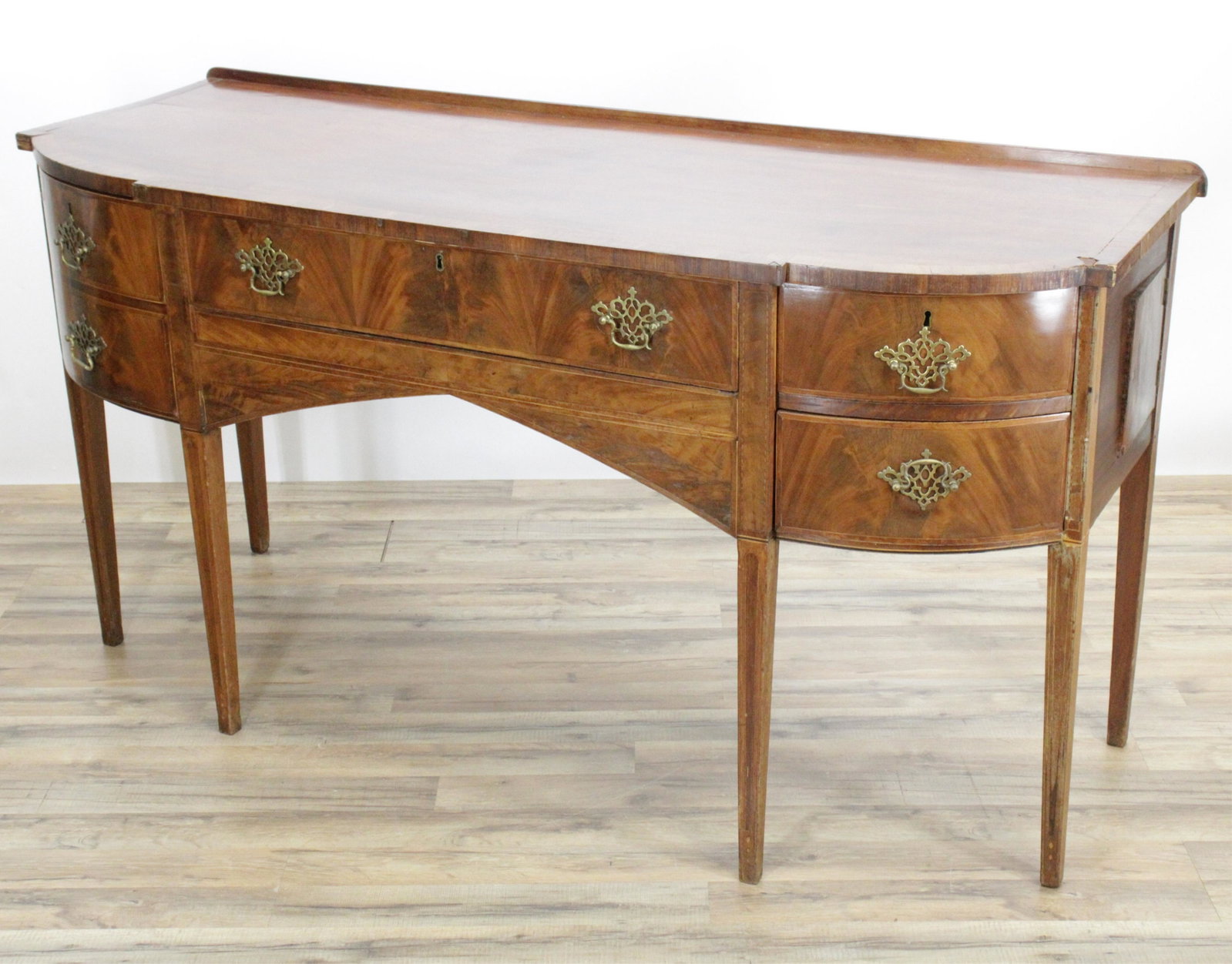 English Sideboard With Cellarette: Fitted bottle cellarette drawer and drawers to front; side chamber door. Full width grain veneer top. Crossband top surface edge and string inlay designs top and front of legs. 69"L x 26W x 35.5 Prope