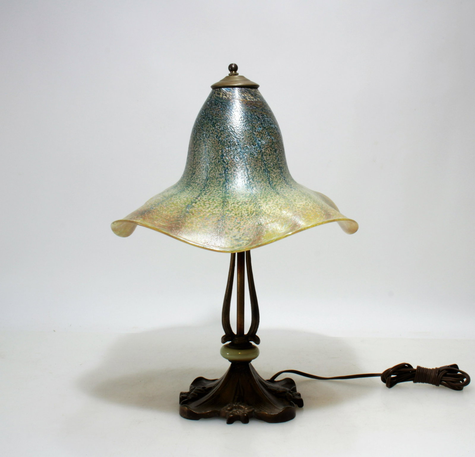 Studio Glass Shade and Base Table Lamp: Gold and blue iridescent "witches hat" form shade with outer surface with soft, very fine "orange peel" texture. Patinated metal base with marble ring. Dimensions:17.5"H x 14 dia. Property from the es