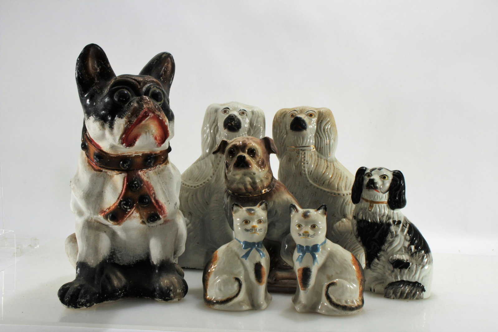 Staffordshire Dog & Cats Figures: Group of 4 Staffordshire Dogs, 2 Cats & a Large Pug Dimensions:Pug 18" H Property from the collection of Dr. William and Mary Smith Liebesman, Deal, NJ.
