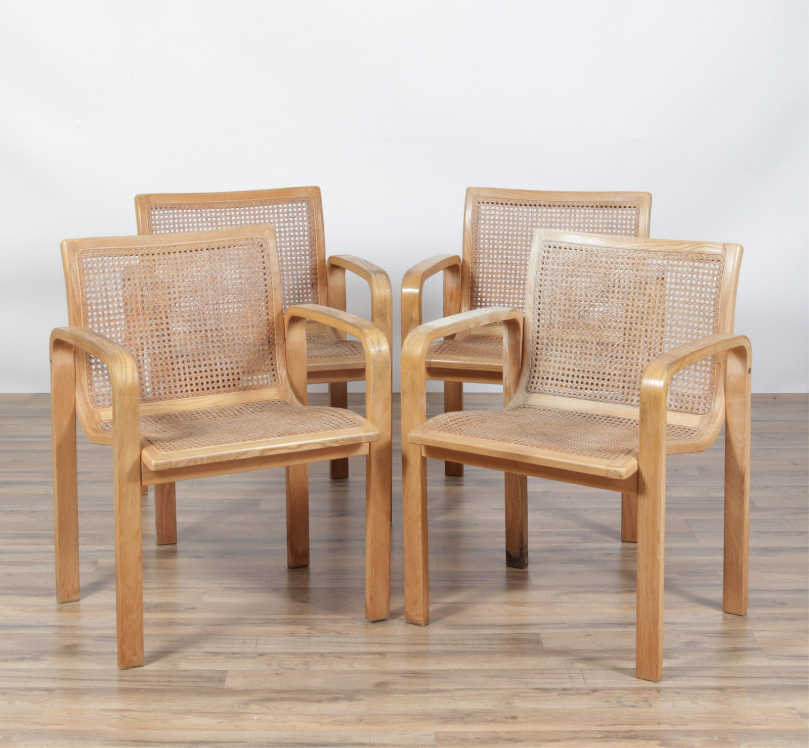 Four Olivo Pietro (Italy) Wood and Cane Armchairs: Two chairs with applied labels. Dimensions:23.5"W x 23.5 deep overall x 31.5H. Seat height 18H Property from the estate of graphic designer, John Noneman.