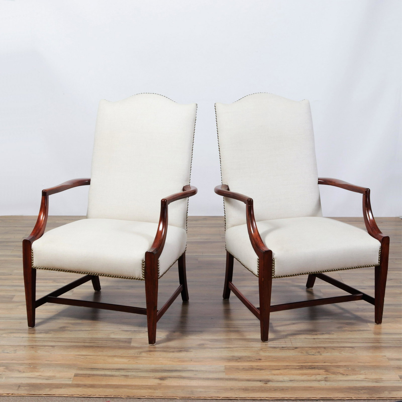 Pair Federal Style Mahogany Lolling Chairs: Pair Federal Style Mahogany Lolling Chairs, upholstered in off-white linen Dimensions:40.75" H x 35.25" W x 30" D Property from the Collection of Scott Newman & Gregory Long.
