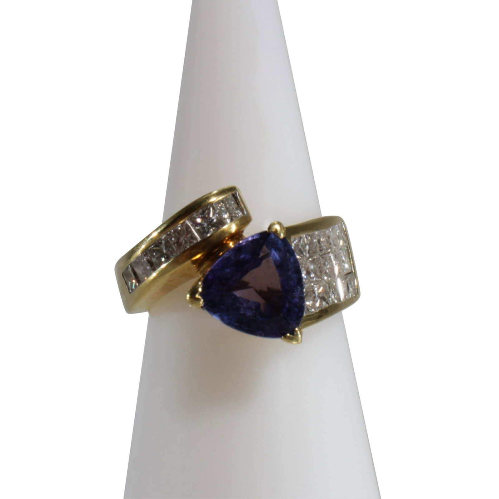 Tourmaline & Diamond Ring: Trilliant cut 0.92 ct tourmaline flanked by 21 princess cut diamonds weighing approximately 0.46 ct, set in 18k yellow gold. Size 7. Gross weight of 10.7 grams. Property from a longtime collector, Col