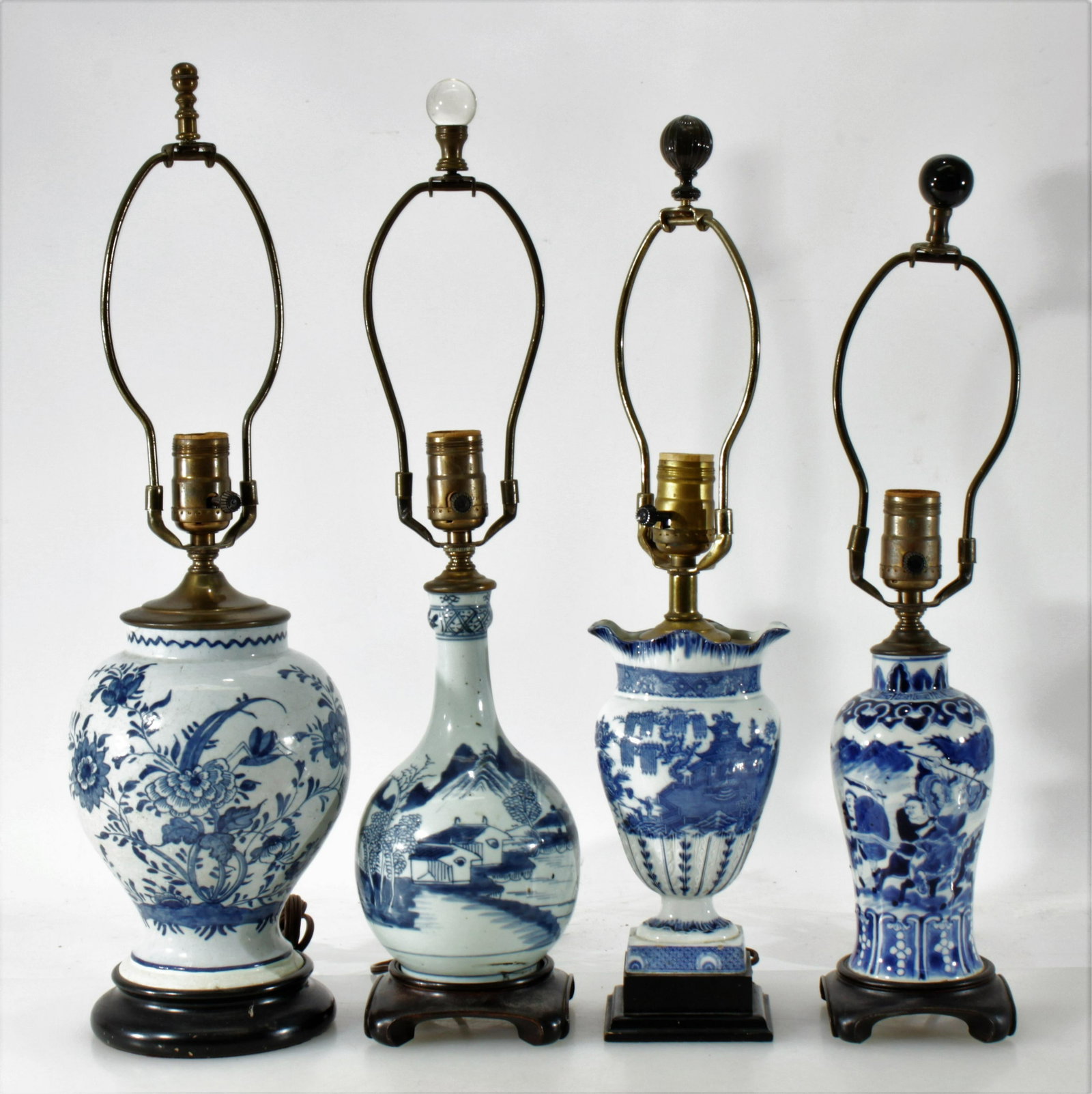 Antique Chinese Porcelain Vase Form Table Lamps: L19/E20C blue and white floral and landscape motif vase forms made into table lamps. One overall floral bulbous vase/jar for example possibly of European origins. Hardwood bases. Dimensions: Larger fl