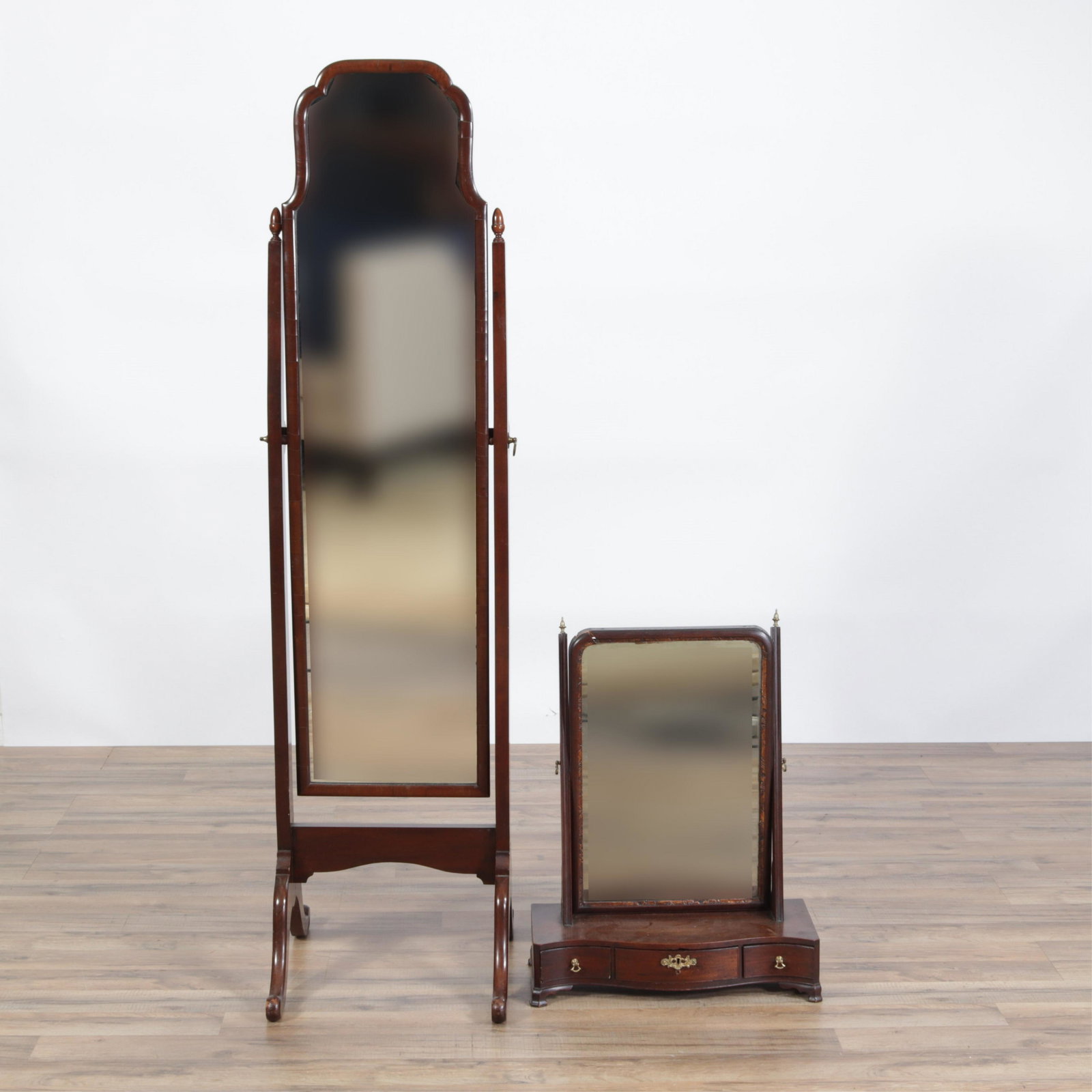 Two Mirrors: 19C Shaving Stand and a Cheval Form: Dresser-top English shaving stand mirror vanity with three drawers, bracket feet, brass acorn finials. Cheval with acorn finialed turned posts. Dimensions: Stand: 25"H x 19W x 8.5 Cheval 62 x 16.5 x 1