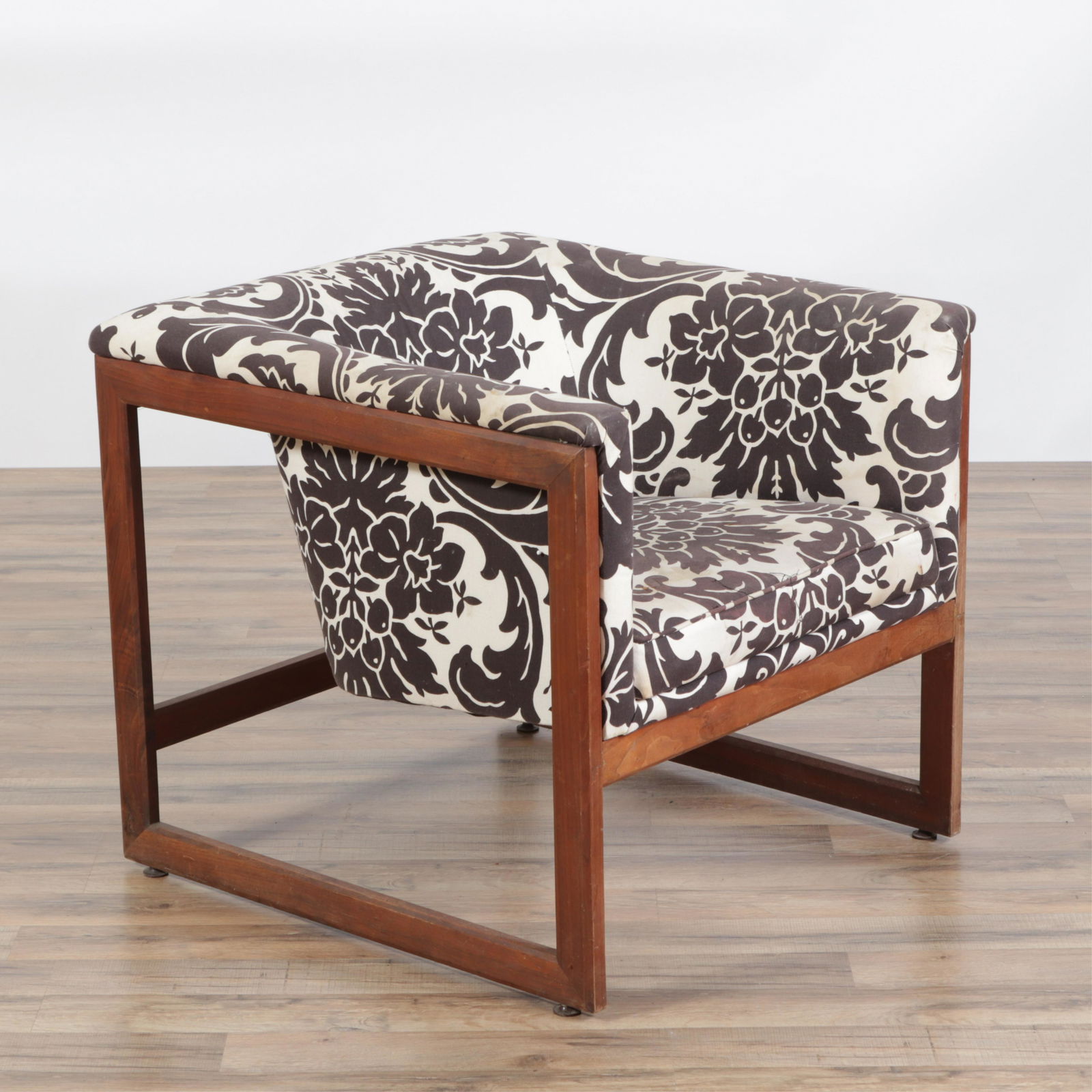 Milo Baughman Walnut 'Floating Cube' Chair: Milo Baughman Walnut 'Floating Cube' Armchair by Monarch Furniture, upholstered in foliate printDimensions: 26" H x 27" W x 29" D