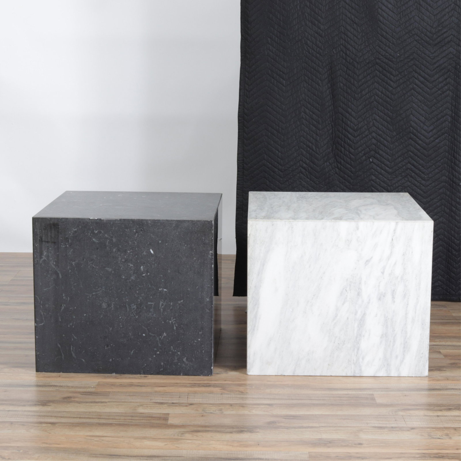2 Marble Square Tables/ Pedestals: Dark Slate color is 21" h by 23.75 square. With some surface scratches, scuffs. White color is 21" H by 24" square. One bottom corner has a vertical crack, minor chips, plus use wear. Each has an open