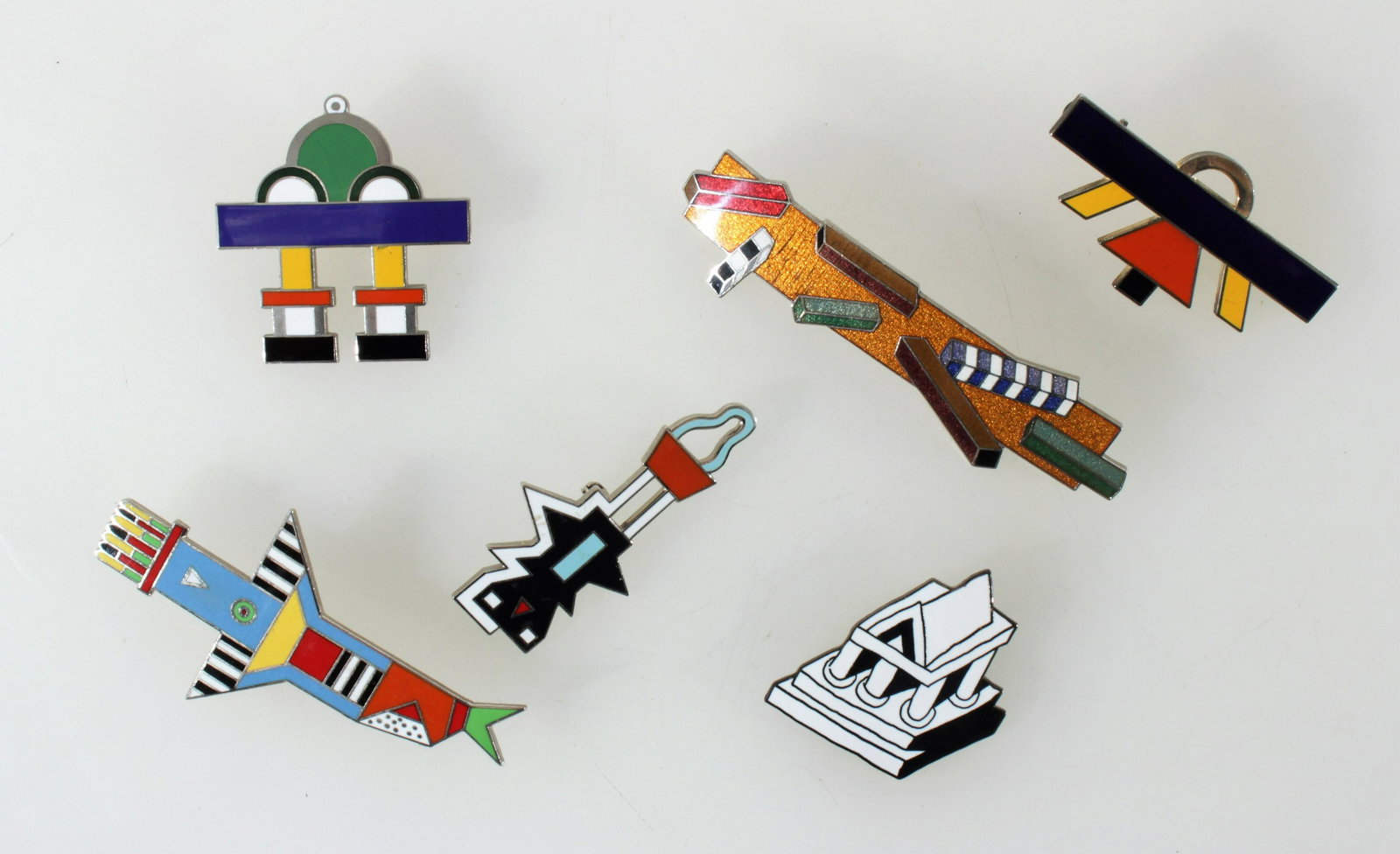 Memphis Designers for Acme - Group of Pins: Memphis Designers for Acme - Group of Pins.Nathalie Du Pasquier, Ninib and Istar pin. Martine Bedin, Paris pin. Ettore Sottsass, Trono, Monumento, and a third pin. Dimensions: Paris 3.5" long. Propert