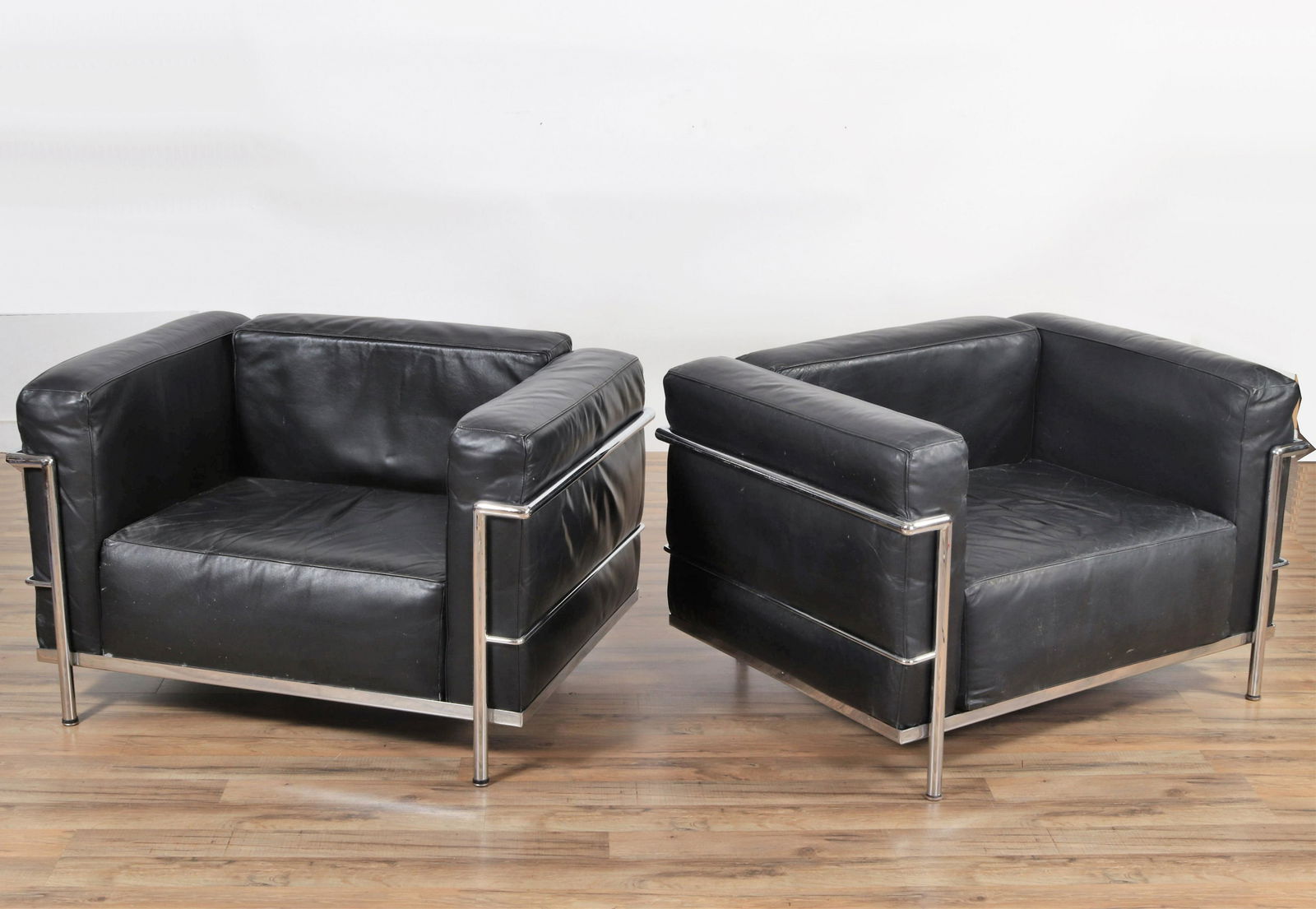 Pair of Le Corbusier LC2 Armchairs: Pair of LC2 armchairs by Le Corbusier, Jeanneret & Perriand. Probably made by Cassina. Labeled Made in Italy. Dimensions: 26" H x 28" W x 26" D Property from the Estate of John 'Parker' Prindle, Jr.,