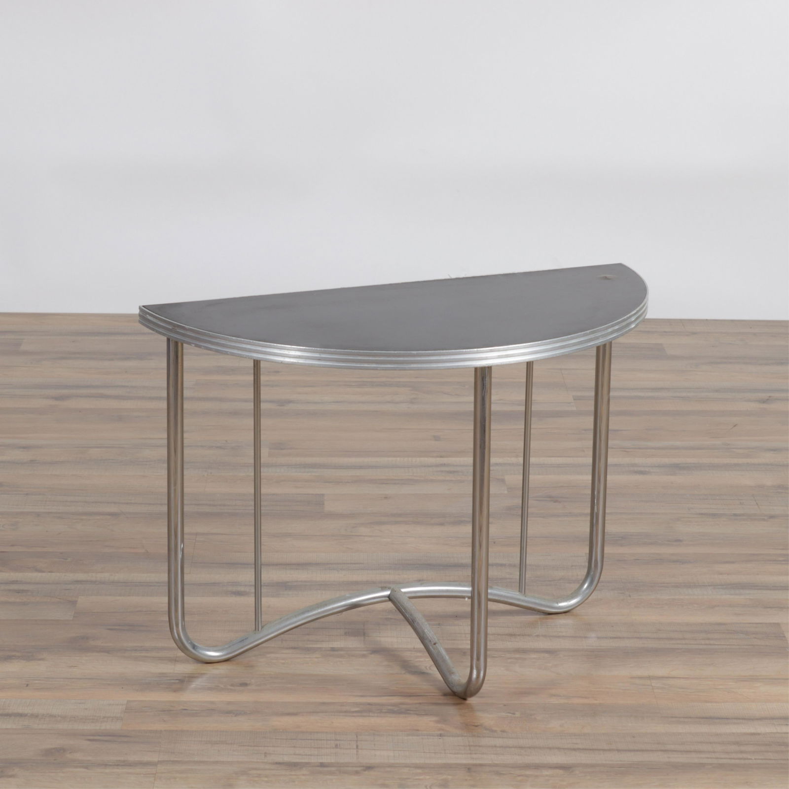 Art Deco Chrome Demilune Table: Art Deco Chrome Demilune Table, possibly Wolfgang Hoffmann. Dimensions: 20" H x 28" W x 13.75" D Property from the Estate of John 'Parker' Prindle, Jr., Boston, MA.