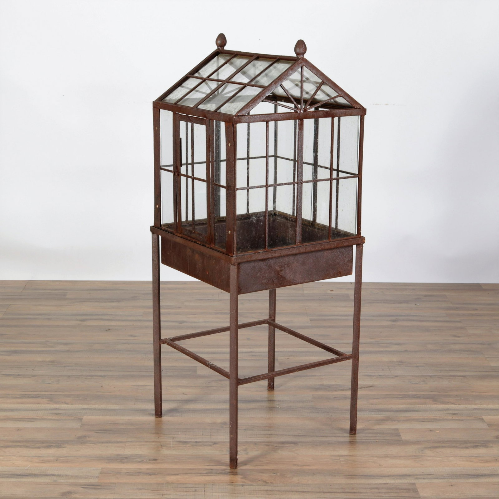 Wrought Iron and Glass Terrarium: Wrought Iron and Glass Terrarium with front door and lift top, acorn finials 49"H x 19"W x 10"W