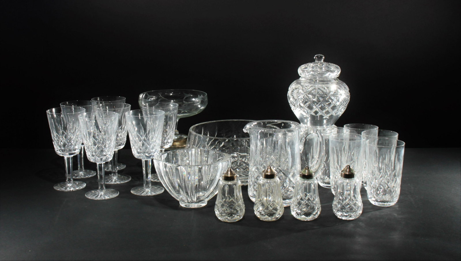 Group of Waterford Cut Glass: Group of Waterford Cut Glass including pitcher, large bowl, salt & peppers, 6 high ball glasses, 7 wine glasses. Together with a Kosta Boda bowl, covered jar, and etched glass & sterling silver pedest