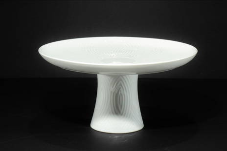 Axel Salto for Royal Copenhagen Cake Stand: Axel Salto for Royal Copenhagen Cake Stand. White ceramic with geometric design. Marked on bottom. Dimensions: 5" H x 10" diam Property from the Estate of John 'Parker' Prindle, JR., Boston, MA.