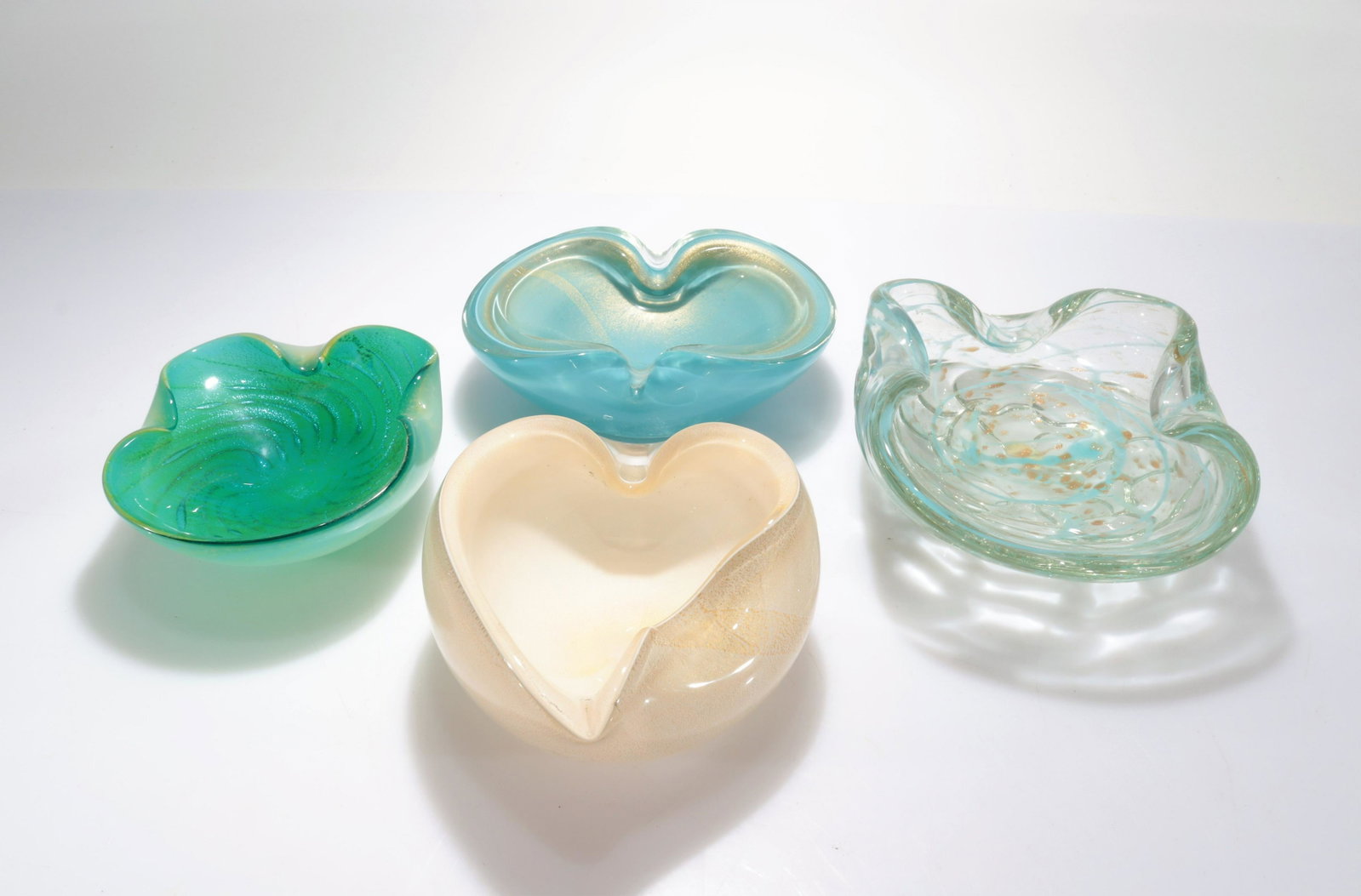 Murano - 4 Glass Ashtrays & Bowls: 4 Murano Glass Ashtrays & Bowls, Mid 20th C., one with applied label Dimensions: Largest 7" Dia. Property from the collection of John 'Parker' Prindle, Jr.