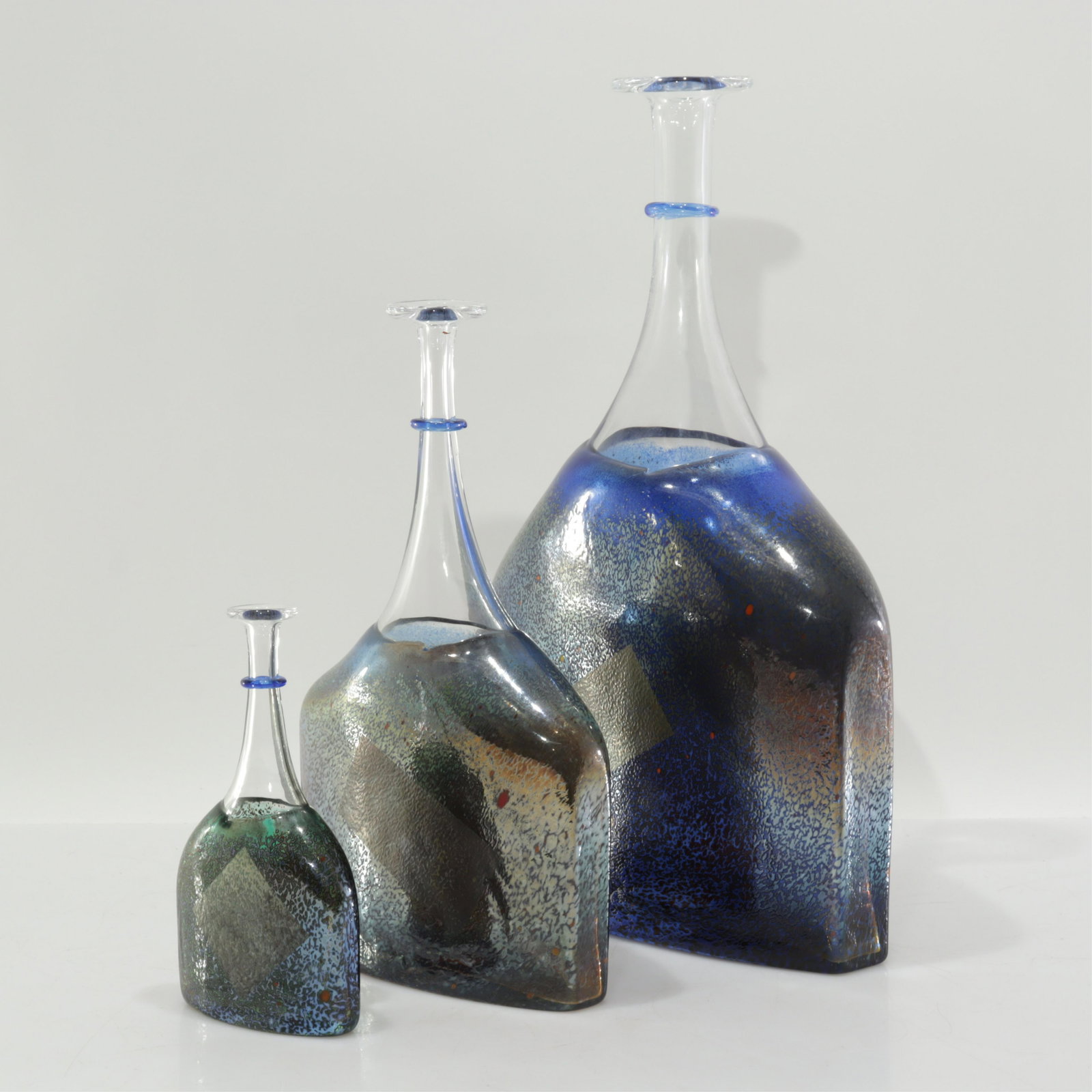 Bartel Vallien Kosta Boda Satelitte Glass Vases: Each etch-signed and numbered in pontil impression. Small and medium with applied Kosta Boda label. In blues with speckle and iridescent finish; fine tactile texture to surface. Dimensions: tall 16.5"