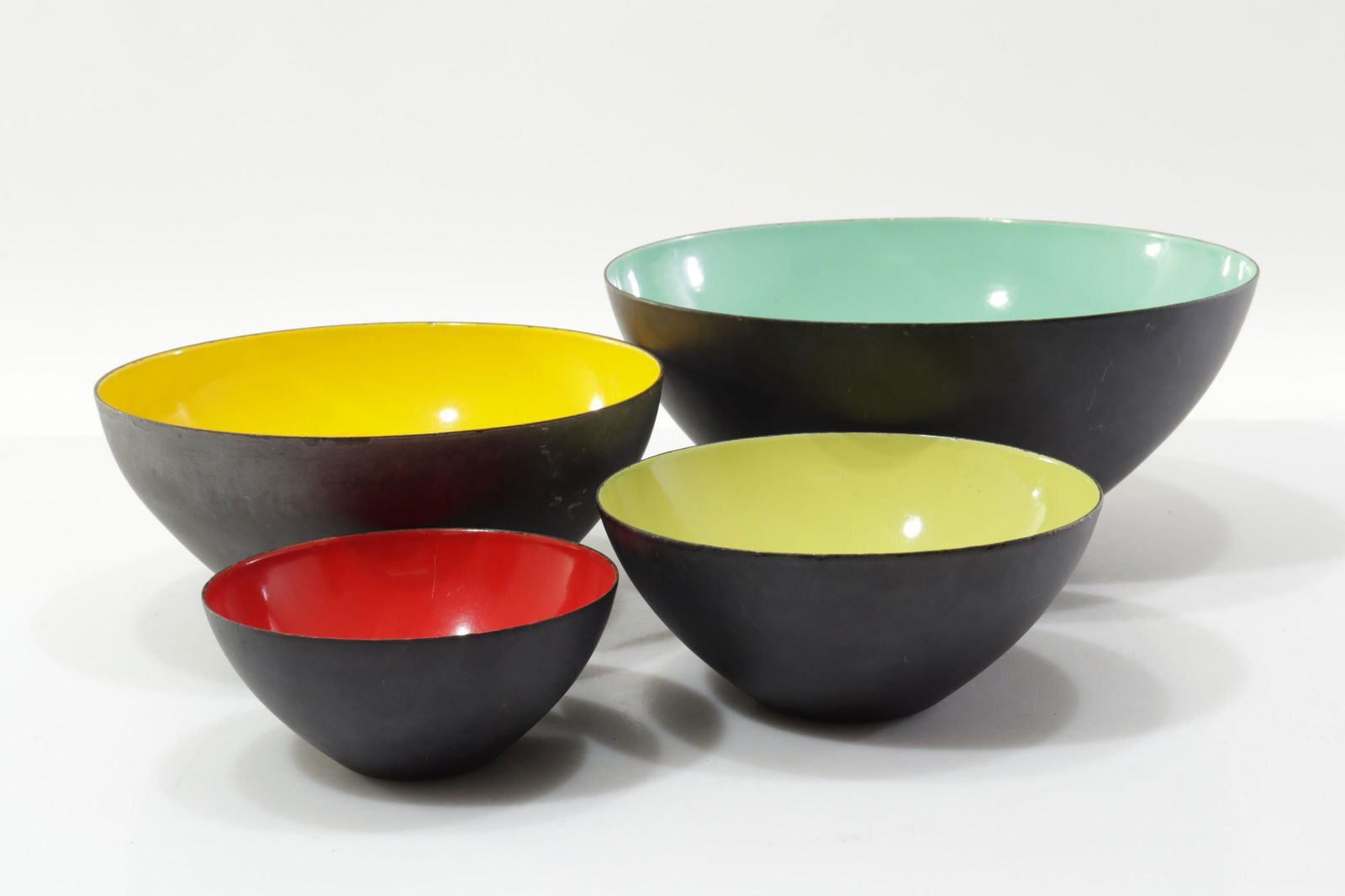 Herbert Krenchel(Denmark) Krenit Bowls,Four Colors: Herbert Krenchel (1922-2014, Danish). Torben Orkson & Co. C1950s. Color enameled steel, matte black finish exteriors.Dimensions: small 2.25"H x 5 dia. large 4.5H x 10 dia.