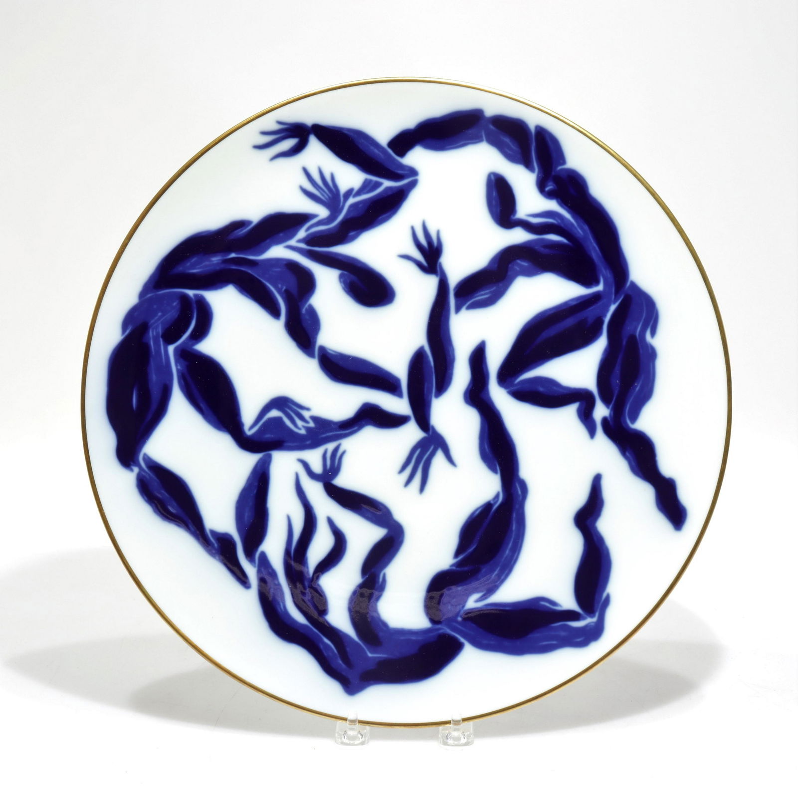 Henri Van derStraeten Bernardaud Porcelain Plate: Henri Van derStraeten design for Bernardaud Limoges (France) French-American Chamber of Commerce Person of the Year Award 2001. Deep blue figures on white ground/field with gold rim.Dimensions: 14.25"