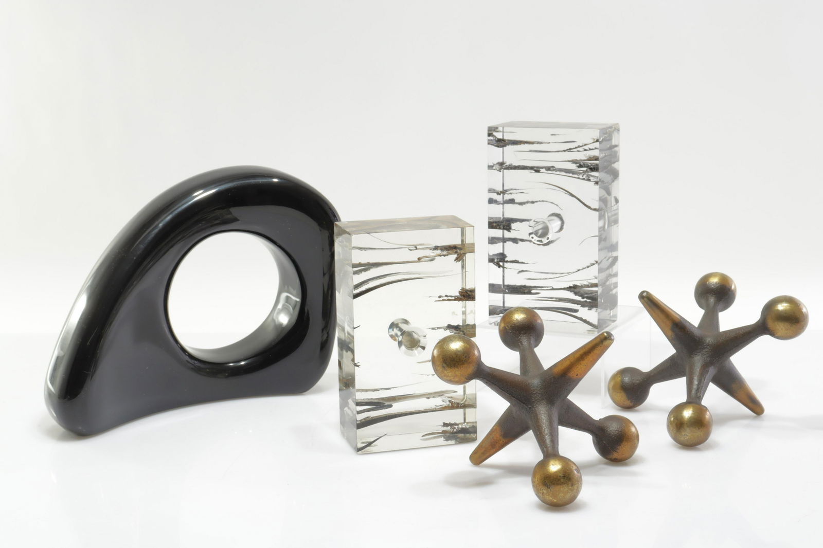 Modern Bookends/Paperweights; Schatz, Seibel Attr.: Pair Zahara Schatz attributed acrylic with linear elements block form, not signed/marked. Pair Ben Seibel attributed bronze "jack" form with darkened finish and brass color ends, not signed/marked. Si