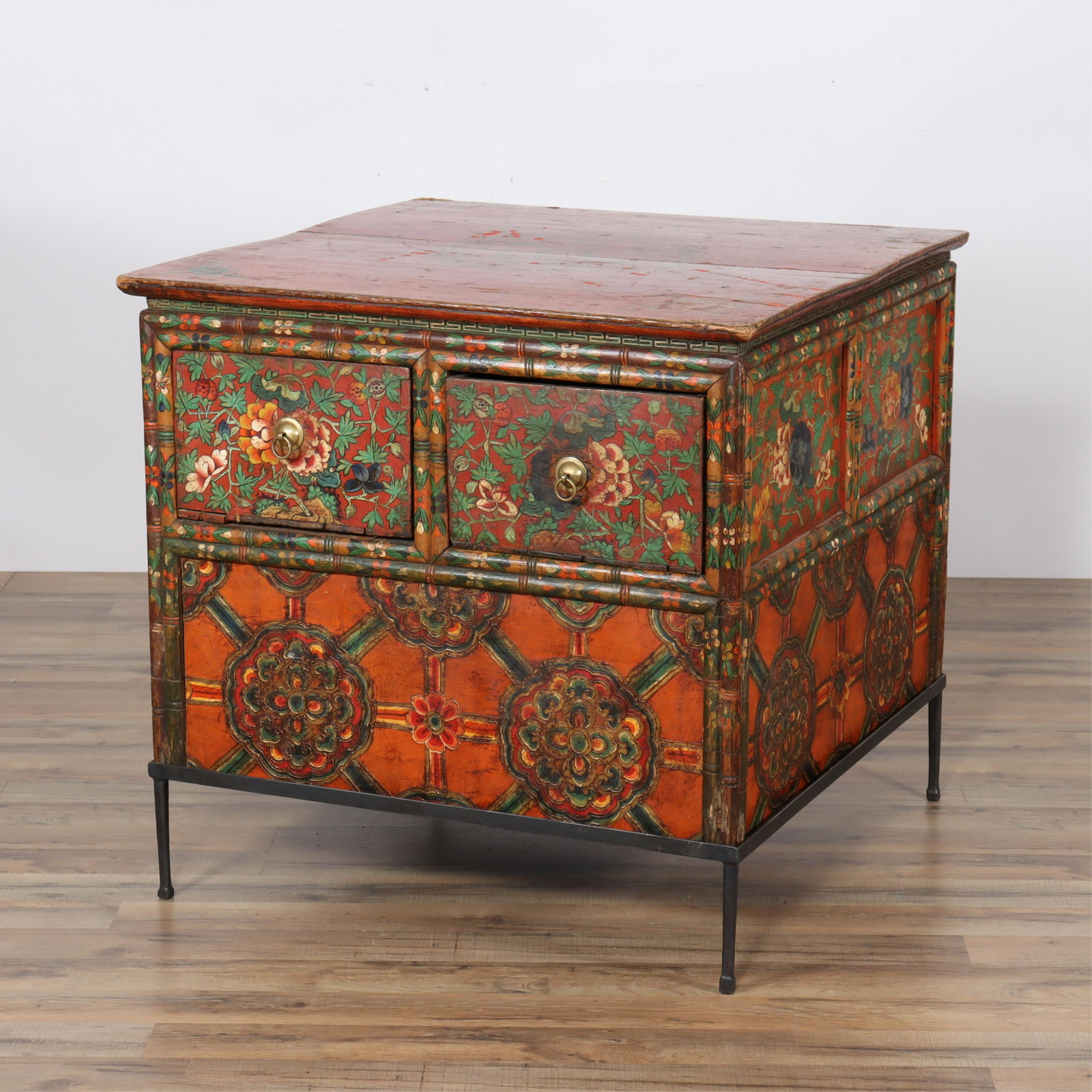 Large Tibetan Polychromed End Table: Large Tibetan Polychromed End Table, on metal stand, decorated with foliate & medallionsPurchased at Seret & Sons, Santa Fe Dimensions: 24.25" H x 31.25" square Property from a Manhattan Interior Desi