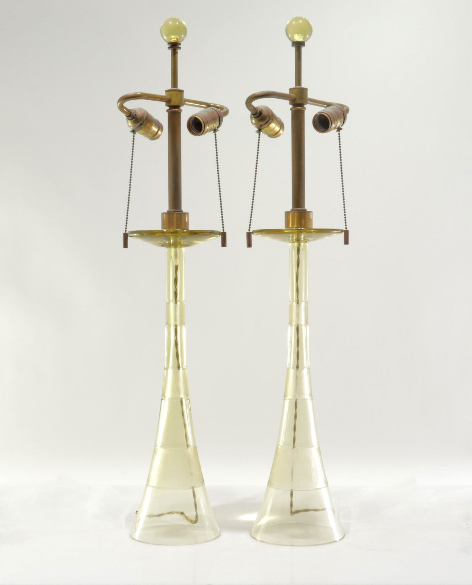 Pair Vintage John Hutton for Donghia Glass Lamps: Italy C1980s.Two pull chain socket fixture scrolled arms each. One with etch-signed "DONGHIA" at base. Threaded for set screws near finial.Dimensions: 30.5"H x 5.25W a t base