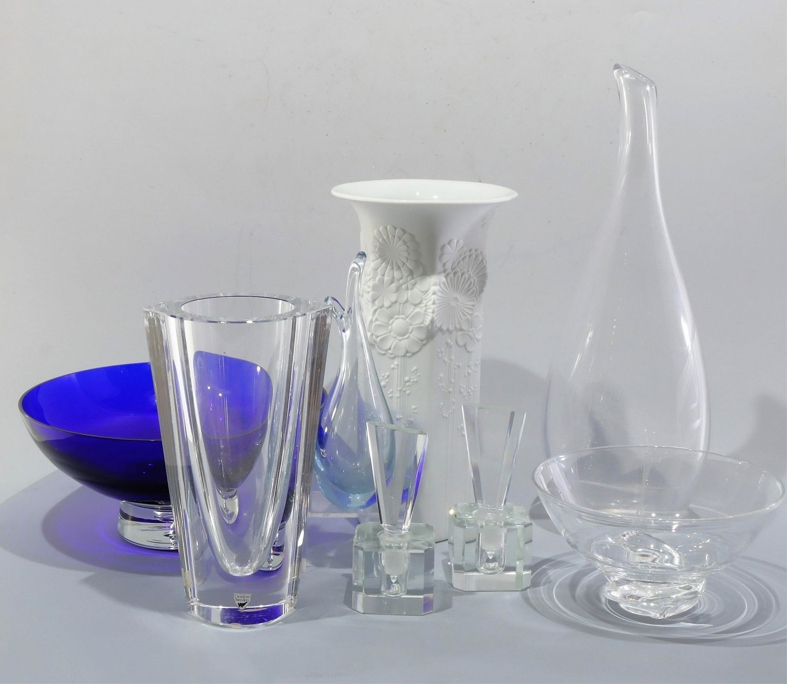 Modern Glass Vases - Steuben, Holmegaard, Orrefors: 1.Orrefors heavy glass vase with paper label 2.tall neck vase with spiderweb etch/cut motif 3. Kaiser bisque porcelain 4.Holmegaard pale blue elongated and flared rim 5.deep/cobalt blue with clear bas