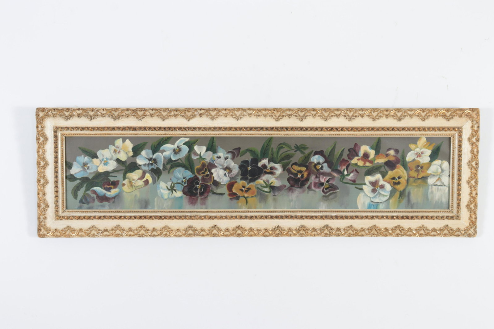 19th C. Victorian Pansies Long Horizontal, O/C: Dec. 21 1886 stamped impressed into back of stretcher wood. Gold and white painted raised garland and beading wood frame. Sight 7.5"H x 39.5 Framed 13.5 x 45.5 Property from a Manhattan and Connecticu