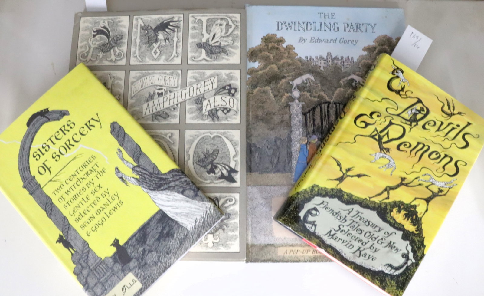 Edward GOREY; Collection: Edward GOREY. Amphigory also. New York: [1983]. Quarto. Illustrated throughout, many in two or more colors. Original pictorial boards, dust-jacket (dust-jacket bumped at head and foot); The Dwindling 