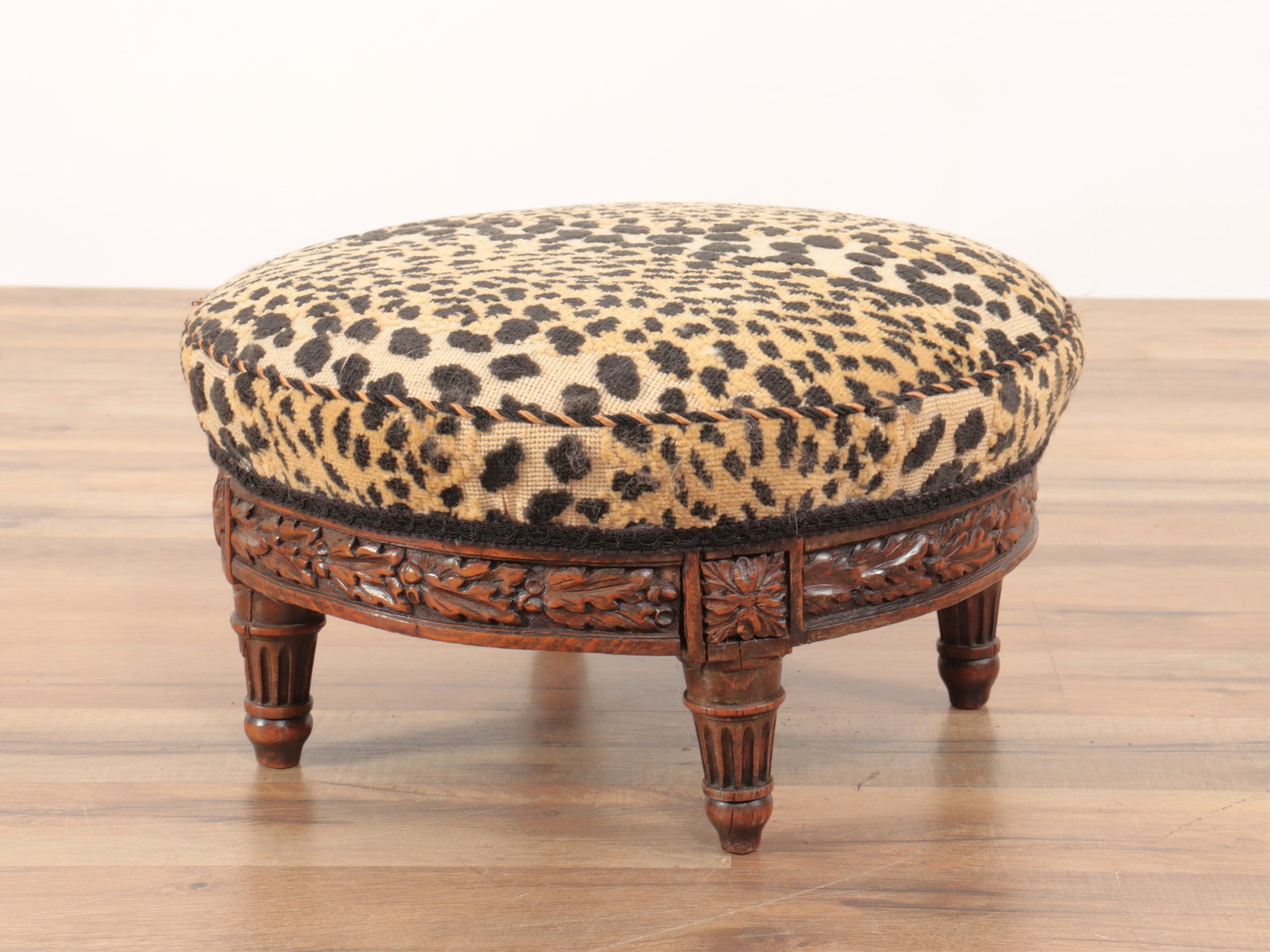 Louis XVI Style Beechwood Footstool: Louis XVI Style Beechwood Footstool, upholstered in cheetah velour. 9.5" H x 15" diam